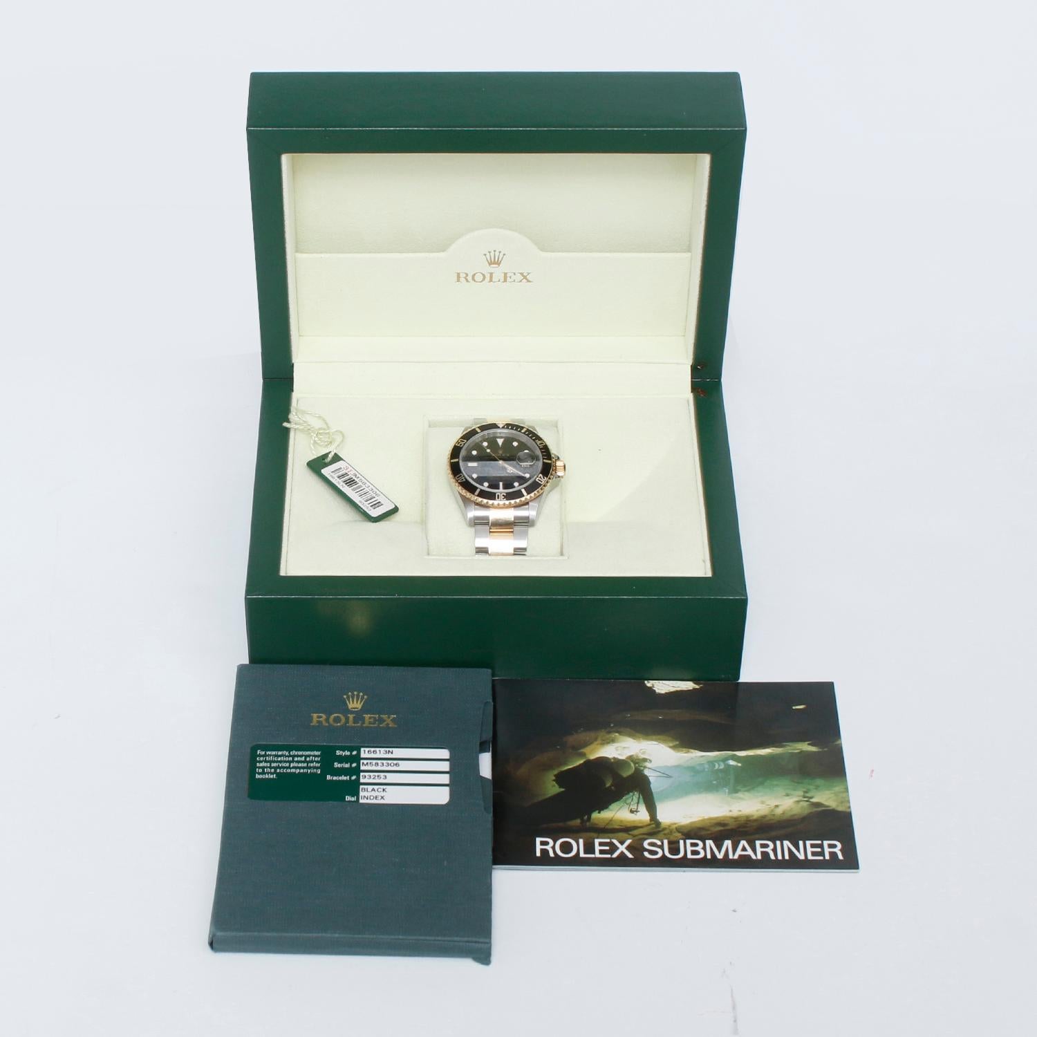 Rolex Submariner 2-Tone Steel & Gold Men's Watch 16613 - Automatic winding, 31 jewels, pressure proof to 1,000 feet. Stainless steel case with 18k yellow gold bezel (40mm diameter). Black dial with luminous markers; date at 3 o'clock. Rolex Two-
