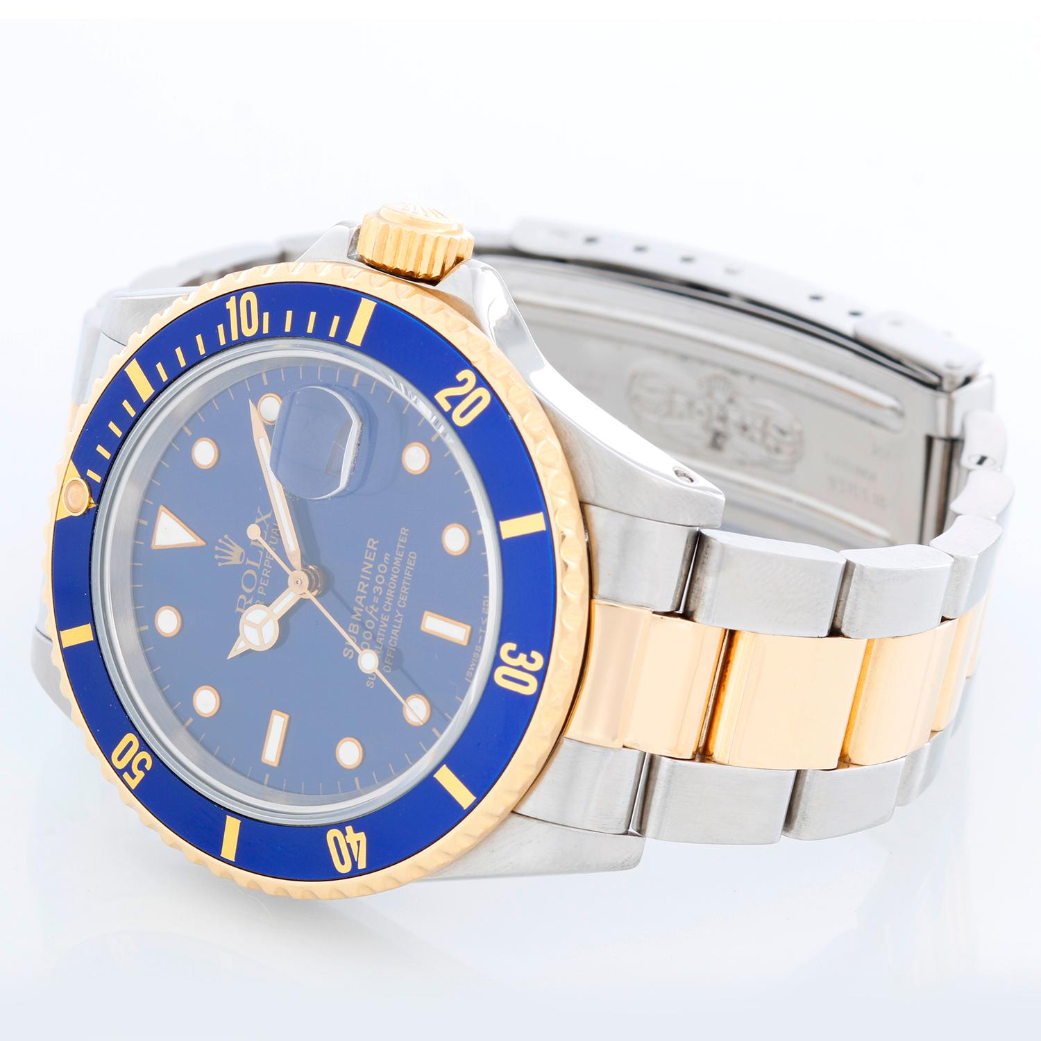 Rolex Submariner 2-Tone Steel & Gold Men's Watch Transitional Model 16803 - Automatic winding, 31 jewels. Stainless steel case with 18k yellow gold bezel with blue insert (40mm diameter). Blue dial. Stainless steel and 18k yellow gold Oyster