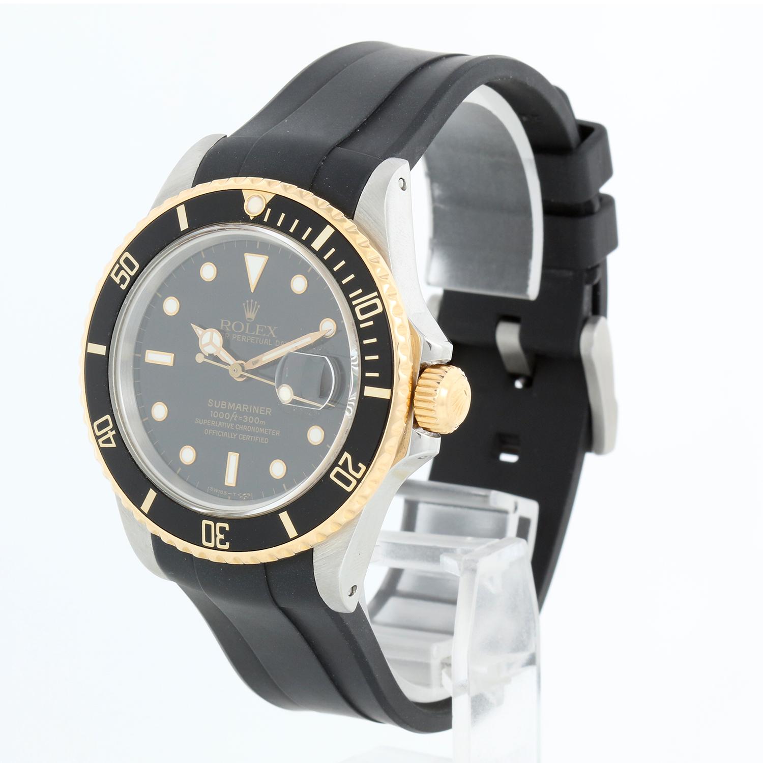 Rolex Submariner 2-Tone Steel & Gold Men's Watch Transitional Model 16803 - Automatic winding, 31 jewels. Stainless steel case with 18k yellow gold bezel with black  insert (40mm diameter). Black  dial. Black rubber B strap. Pre-owned with Rolex