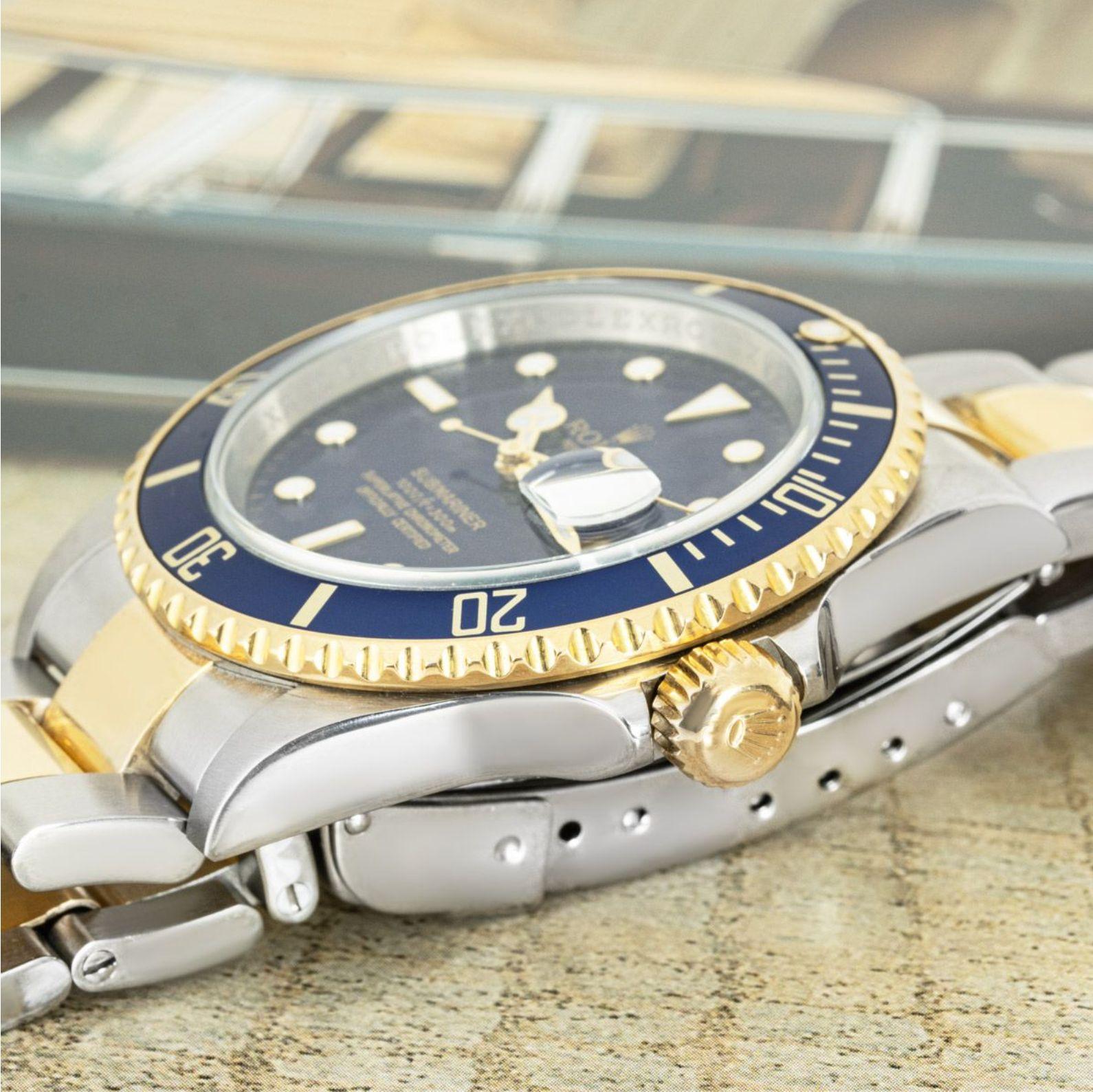 A stainless steel and yellow Submariner Date by Rolex. Featuring a blue dial and a yellow gold uni-directional rotating bezel and a blue bezel insert. Fitted with a sapphire glass and a self-winding automatic movement. The watch is also equipped