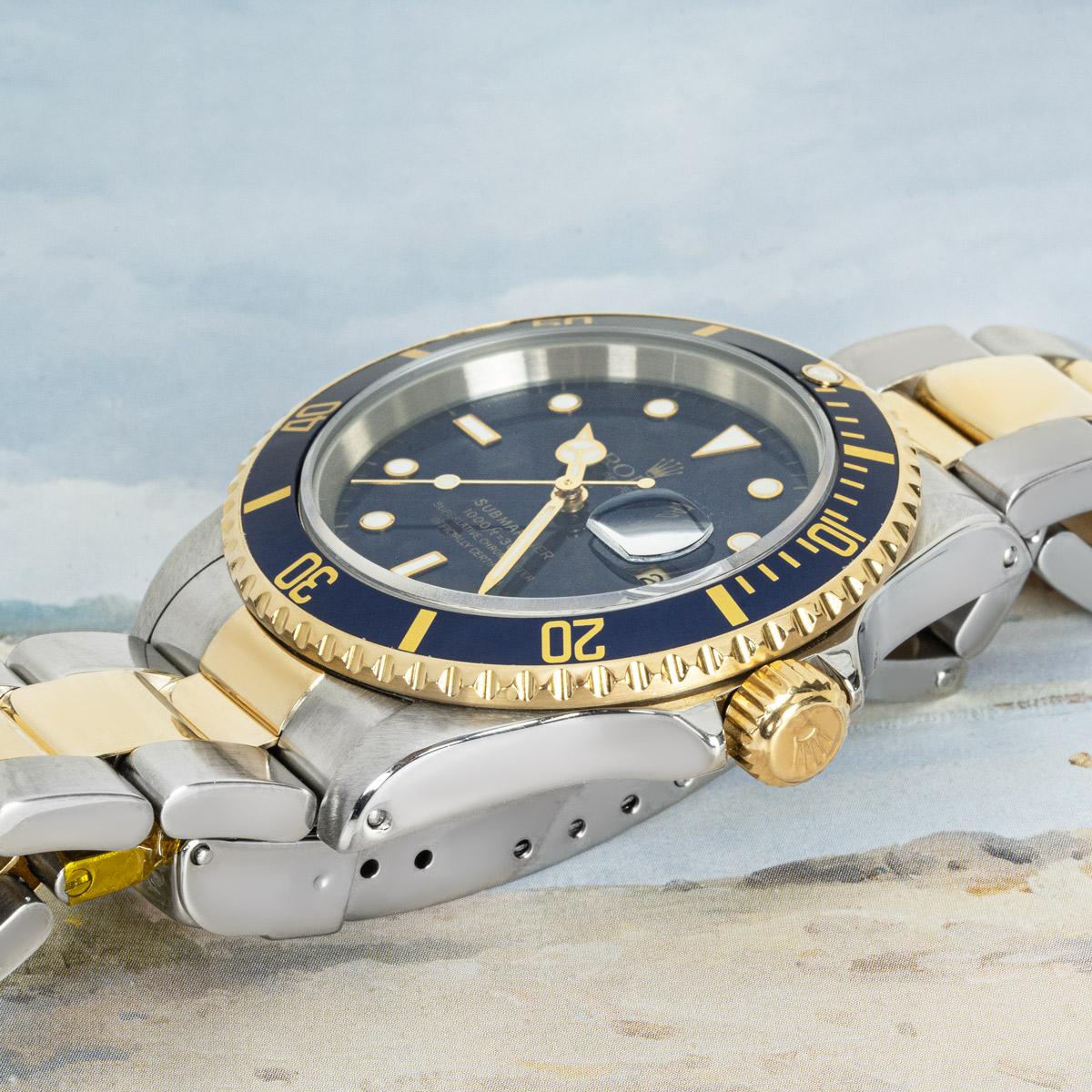 A 40mm steel and yellow Submariner Date by Rolex. Features a blue dial with applied hour markers, a yellow gold uni-directional rotating bezel and a blue bezel insert. Fitted with a sapphire glass, a self-winding automatic movement, a stainless