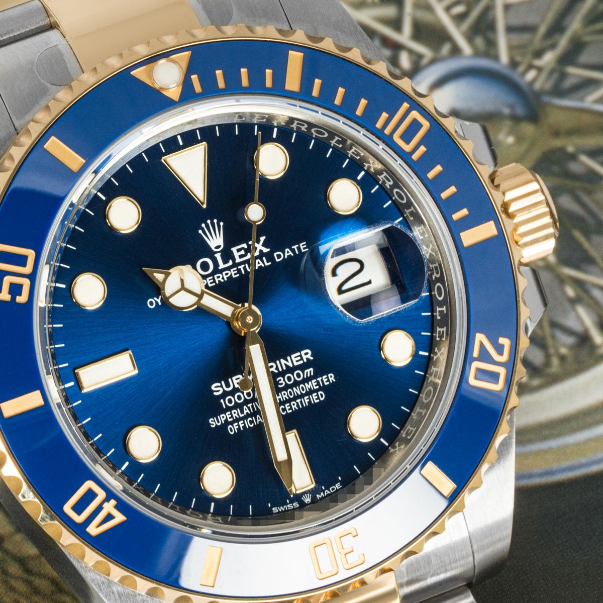 An unworn 41mm Submariner Date in Oystersteel and yellow gold by Rolex. Featuring a royal blue dial with luminescent hour markers. The yellow gold uni-directional rotatable bezel has a blue ceramic insert, with 60-minute graduations coated in