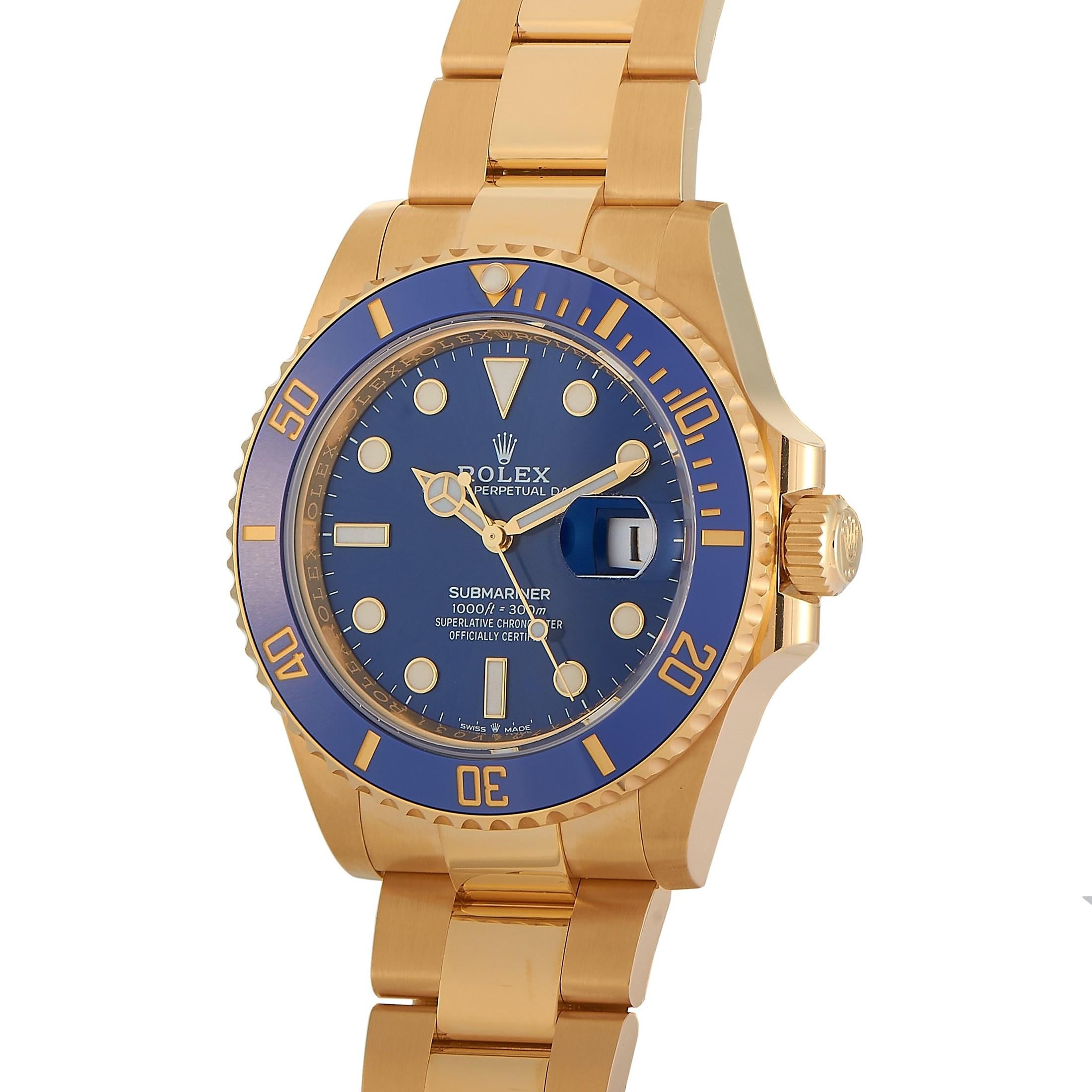 This stately Rolex 18K Yellow Gold Perpetual Submariner Date 41 mm Watch, reference number 126618LB, features an 18K Yellow Gold case measuring 41 mm in diameter with a uni-directional rotating blue ceramic Bezel. The watch is presented on a