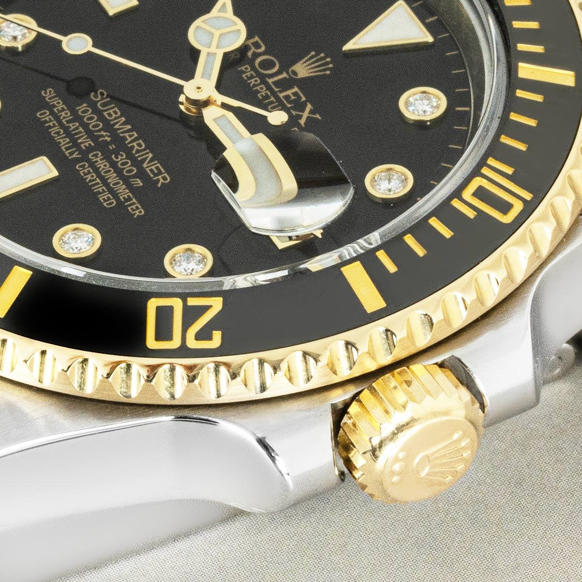 A 40mm Submariner Date in stainless steel and yellow gold by Rolex. Features a black diamond set dial, complemented by a yellow gold uni-directional rotatable bezel which has a black ceramic insert.

Fitted with scratch-resistant sapphire crystal, a