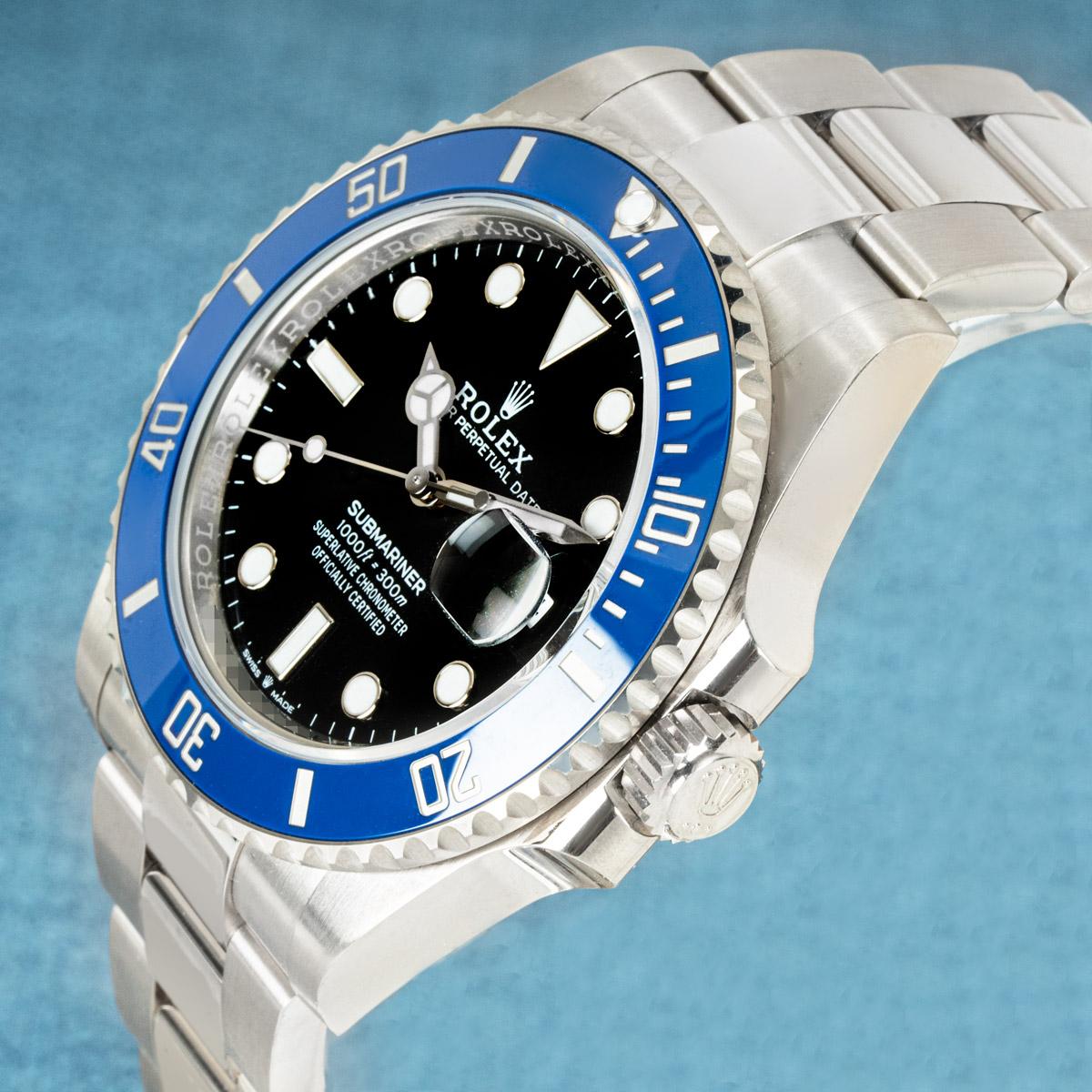 An unworn 41mm Submariner Date in white gold by Rolex. Featuring a black dial and a blue ceramic unidirectional rotatable bezel with 60 minute numerals and graduations coated in platinum.

The Oyster bracelet has a folding Oysterlock clasp with the