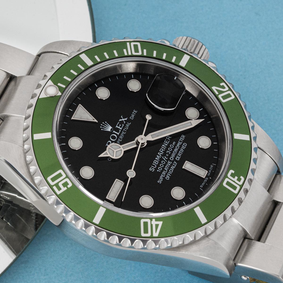 A 40mm Submariner Kermit in steel by Rolex. Features a black dial with applied hour markers and a green unidirectional rotatable bezel set with 60-minute graduations. Fitted with sapphire crystal, a self-winding automatic movement and an Oyster