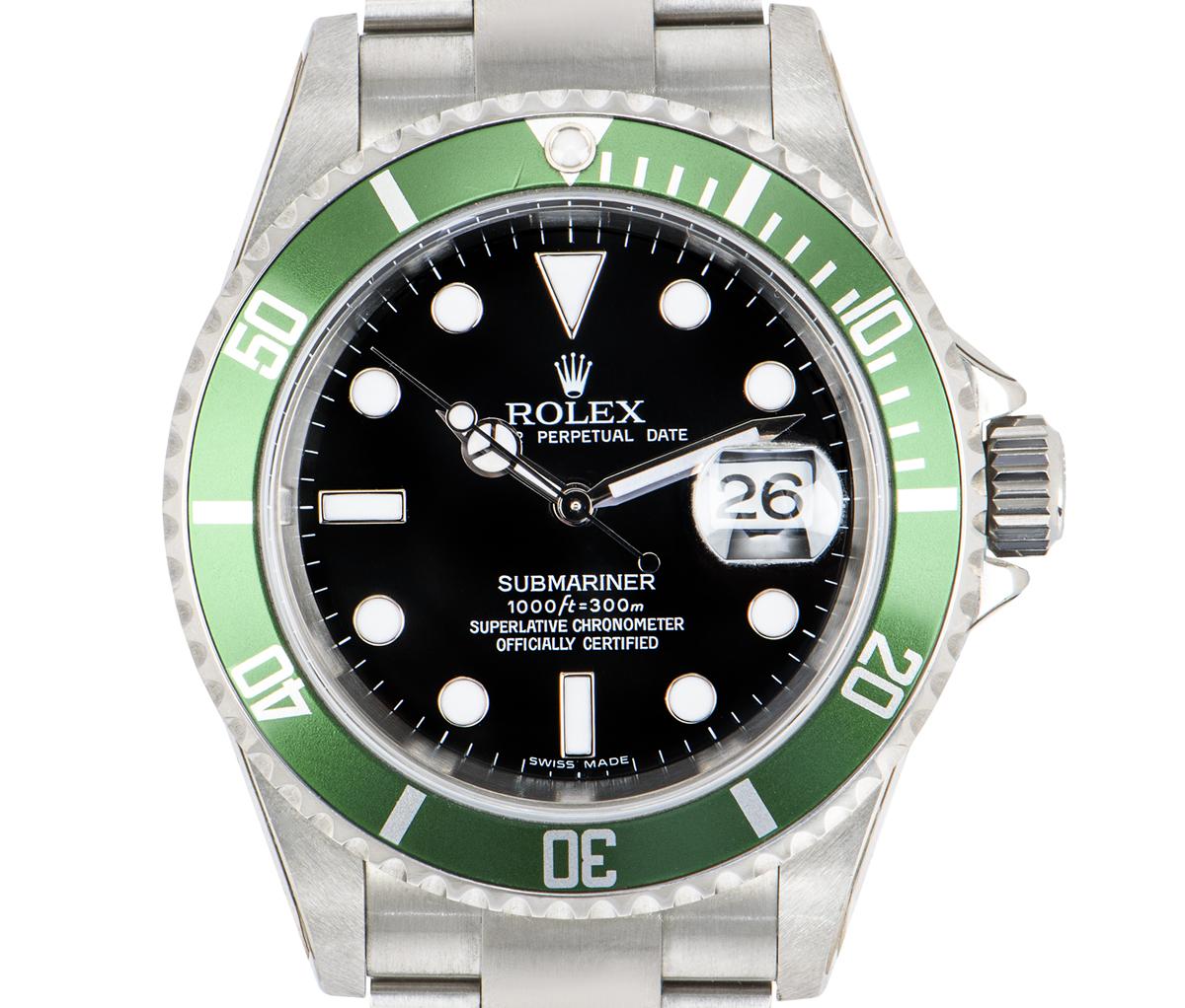 An unworn NOS Submariner Date by Rolex in stainless steel, known as a Kermit. Features a black dial and a green unidirectional rotatable bezel with 60-minute graduations. The Oyster bracelet comes equipped with an Oysterlock deployant clasp. Fitted