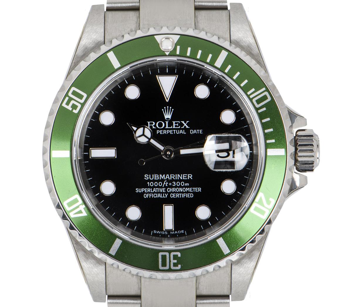 A mens unworn NOS Submariner Date by Rolex in stainless steel, known as a Kermit. Features a black dial and a green unidirectional rotatable bezel with 60-minute graduations. The Oyster bracelet comes equipped with an Oysterlock deployant clasp.