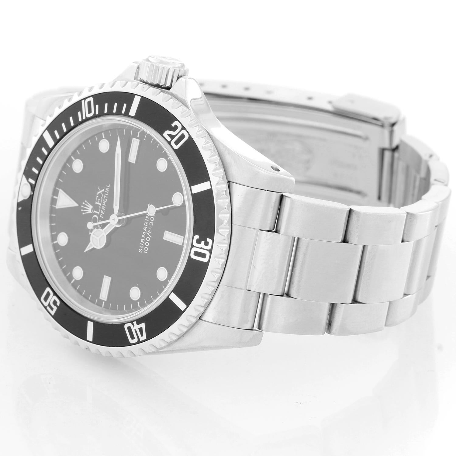 Rolex Submariner Men's Stainless Steel Watch (no-date) 14060 - Automatic winding. Stainless steel case (40mm diameter). Black dial with luminous hour markers. Stainless steel Oyster bracelet with flip-lock clasp. Pre-owned box and books.