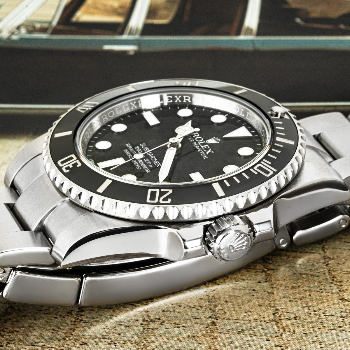 A 40mm Submariner Non-Date, by Rolex in stainless steel. Features a black dial and a black ceramic unidirectional rotatable bezel with 60-minute graduations coated in platinum.

The Oyster bracelet comes with the Oysterlock folding clasp. Fitted