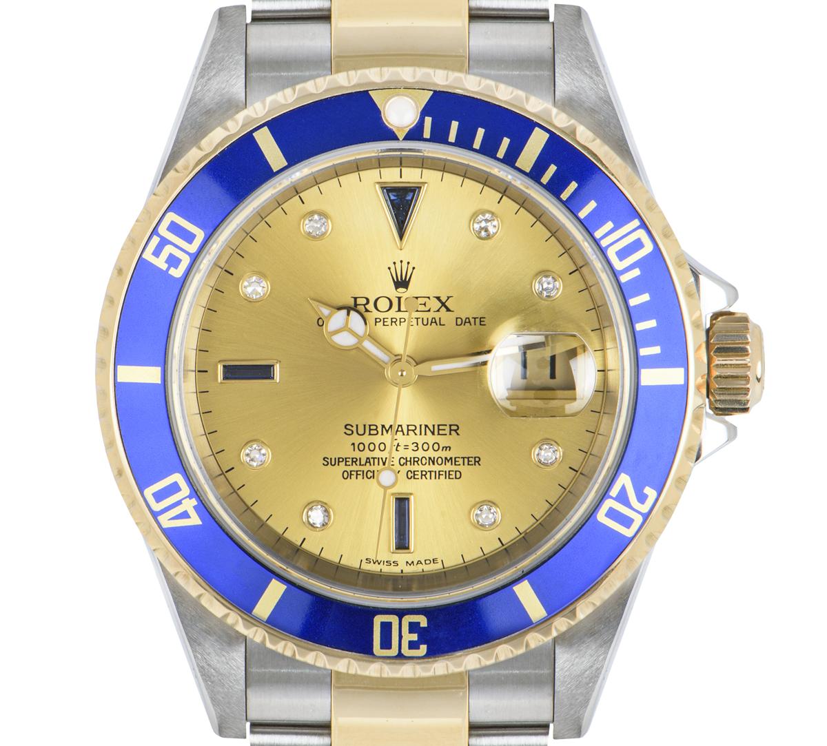 A men's 40mm Submariner in steel and yellow gold by Rolex. Featuring a champagne serti dial set with 8 round brilliant cut diamonds and 3 sapphires. Complimenting the dial is a yellow gold uni-directional rotating bezel with a blue bezel insert.