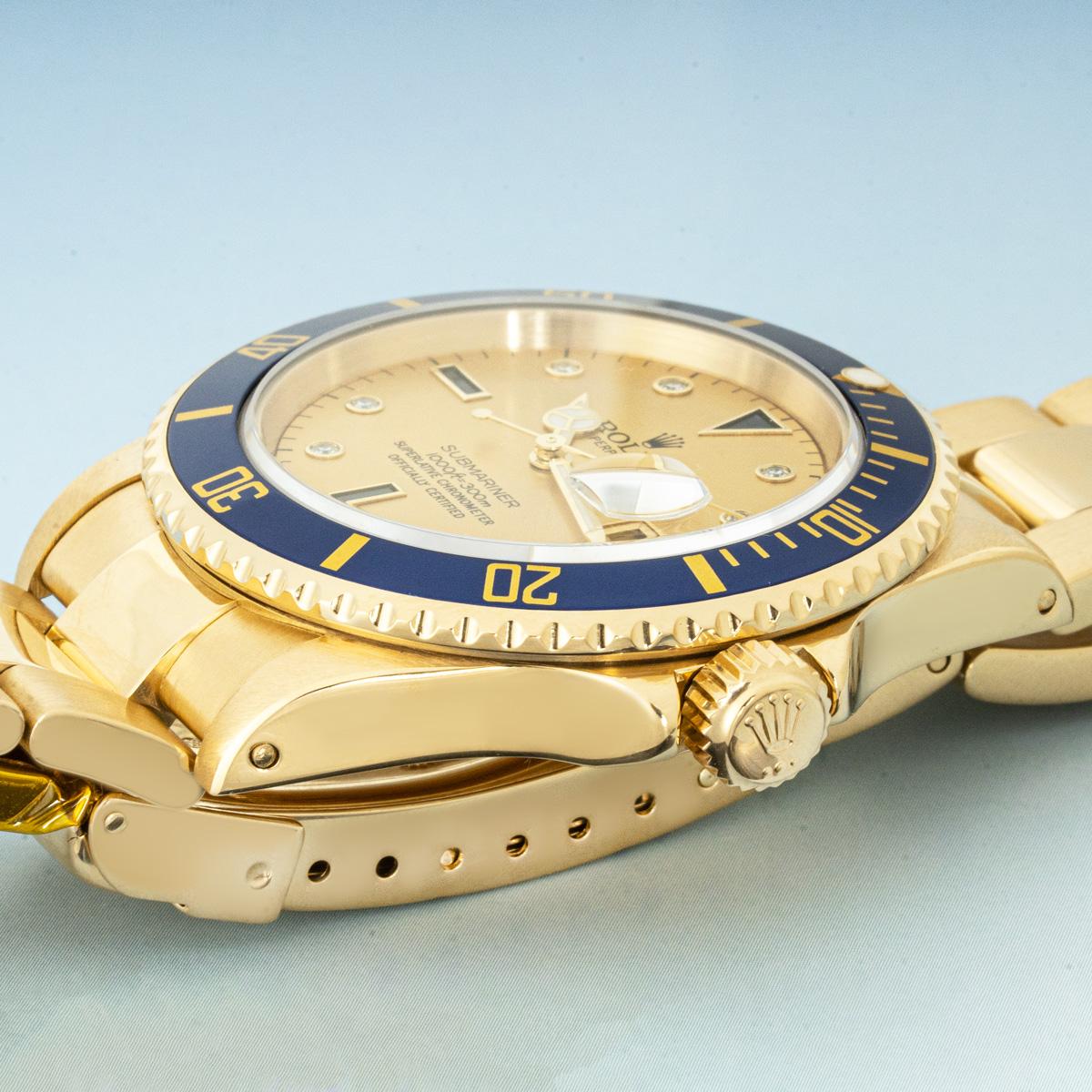 A men's 40mm Submariner in yellow gold by Rolex. Featuring a champagne serti dial (please note, the original dial was replaced with this serti dial during the Rolex service) set with 8 round brilliant cut diamonds, 3 sapphires and a date display.