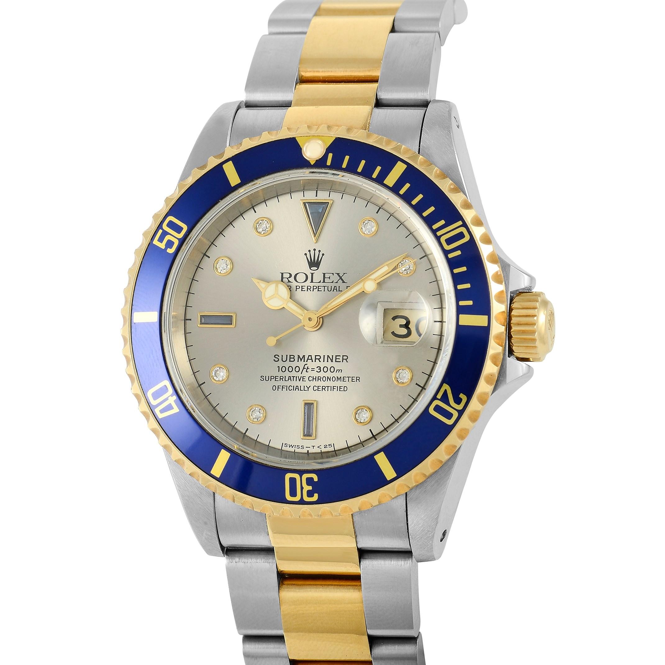 This Rolex Submariner watch, reference number 16613, features a two-tone stainless steel and yellow gold case measuring 40 mm in diameter and includes a ceramic blue rotating fluted bezel. It is presented on a matching bracelet with deployment