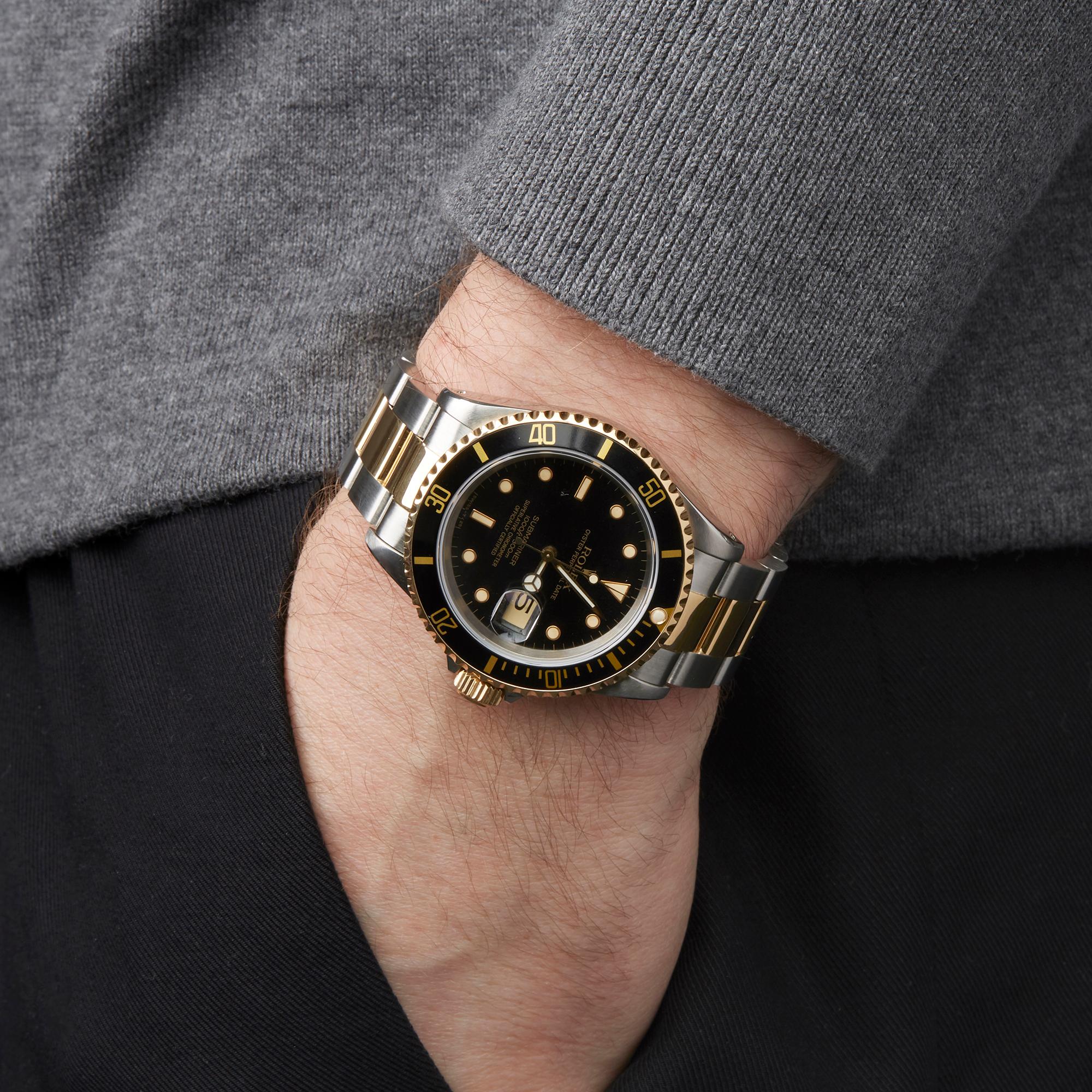 gold submariner on wrist