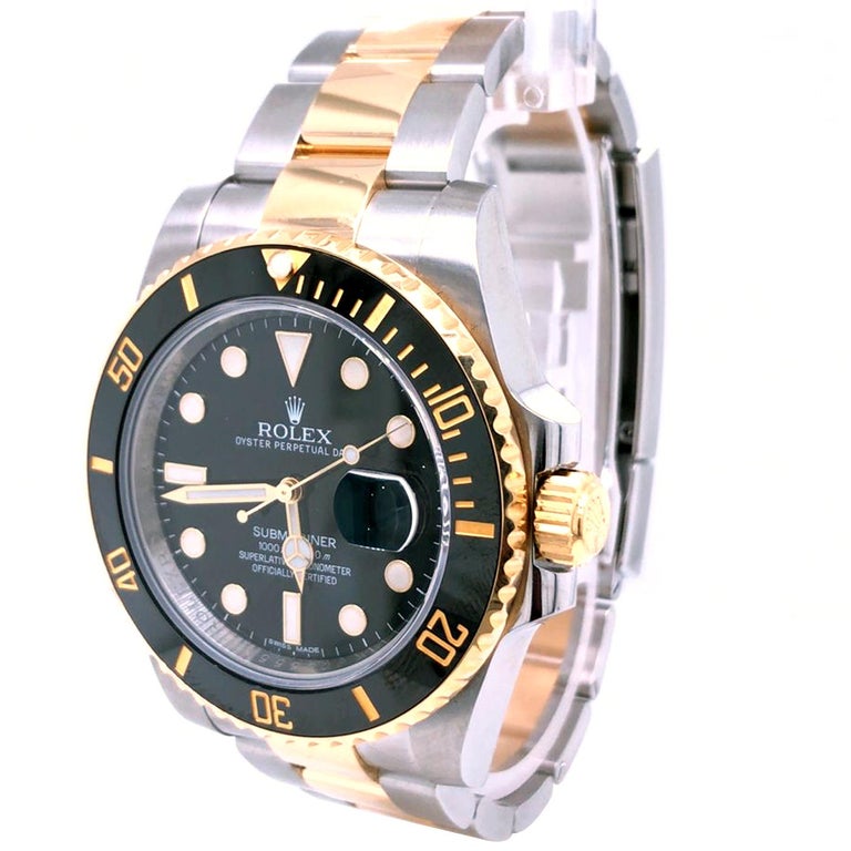 The Rolex Submariner 40mm Oyster Perpetual Date in Oystersteel and yellow gold with a Cerachrom bezel insert in black ceramic and a black dial with large luminescent hour markers. It features a unidirectional rotatable bezel and solid-link Oyster