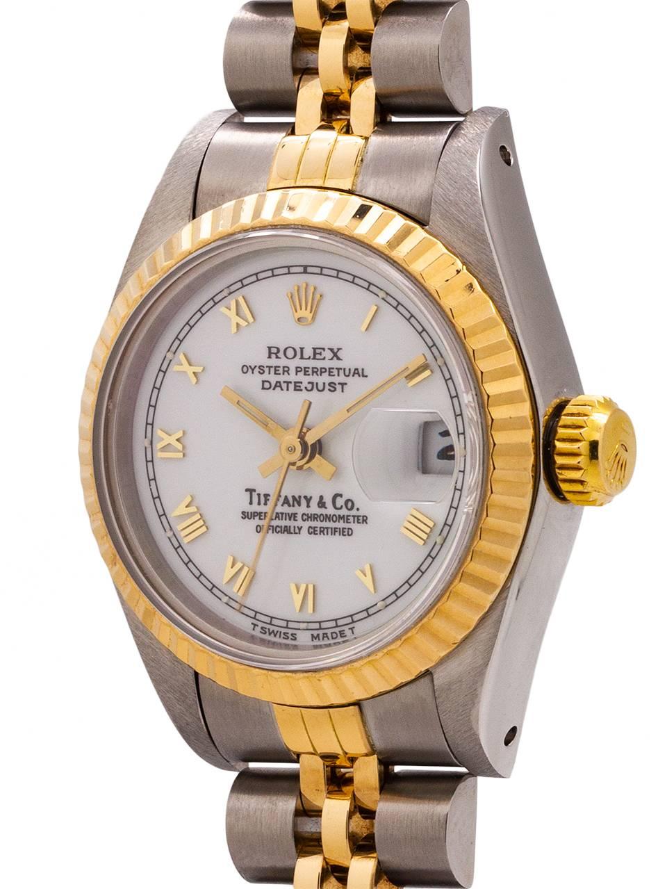 
Lady Rolex Datejust ref 69173 SS & 18K YG L2 serial # circa 1998 retailed by Tiffany & CO. Very desirable double name model featuring 27mm diameter case, 18K YG fluted bezel, sapphire crystal, original white enamel dial signed Tiffany & Co, with
