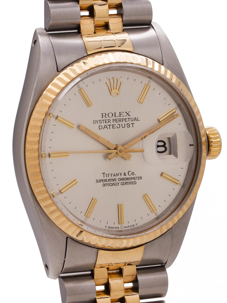Rolex Datejust ref 16013 stainless steel and 18k yellow gold circa 1980 retailed by Tiffany & Co. Featuring full size man’s 36mm diameter case with 18K YG fluted bezel, acrylic crystal, and original silvered satin dial with applied gold indexes and