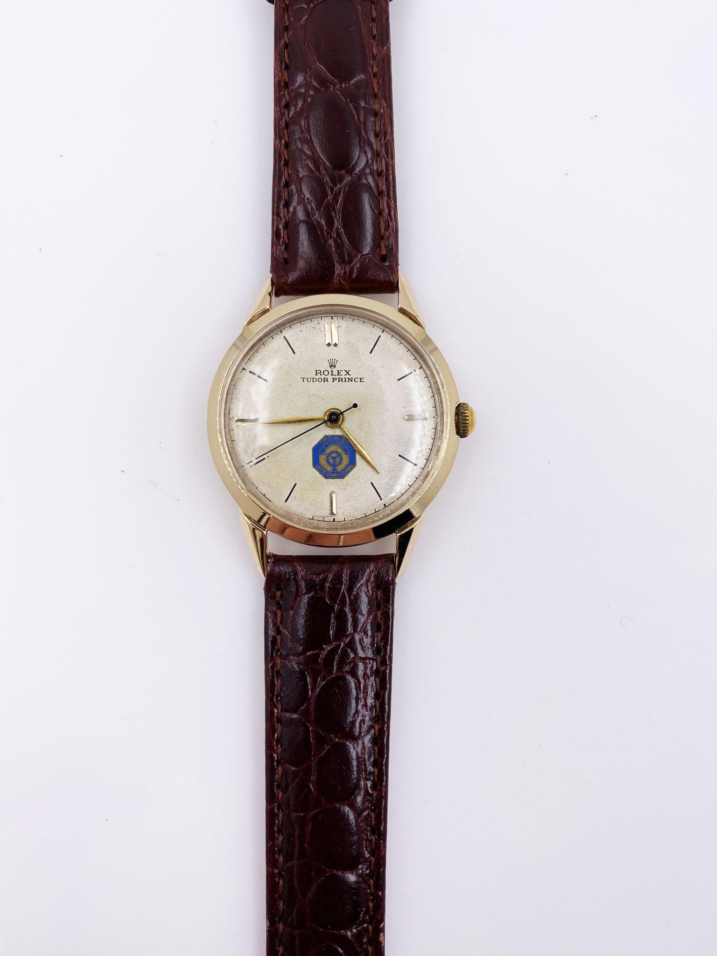 Year: 1959

 

Model: Rolex Tudor Prince Optimist International Distinguished 

 

Case Material: 14K Yellow Gold 

 

Band: Custom Leather Band 

 

Bezel:  14K Yellow Gold

 

Face: Acrylic

 

Case Size: 33mm

 

Includes: 

-Rolex Tudor Box &