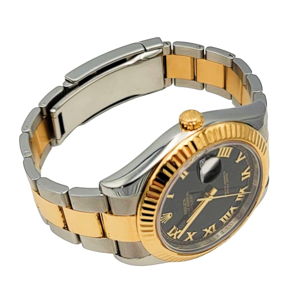 Rolex Two-Tone 18k Yellow Gold and Steel Unisex Watch. Black dial with Roman Numerals and fluted bezel. All links with box. Automatic movement with 31 jewels. Available with an aftermarket 18k
gold diamond bezel.