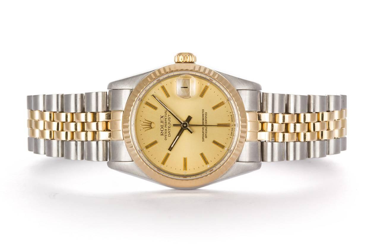We are pleased to offer this 1987 Two Tone Stainless Steel & 18k Yellow Gold 31mm Ladies Rolex Datejust 68273. It is all original Rolex and features an 18k yellow gold fluted bezel, champagne stick dial, stainless steel & 18k yellow gold jubilee