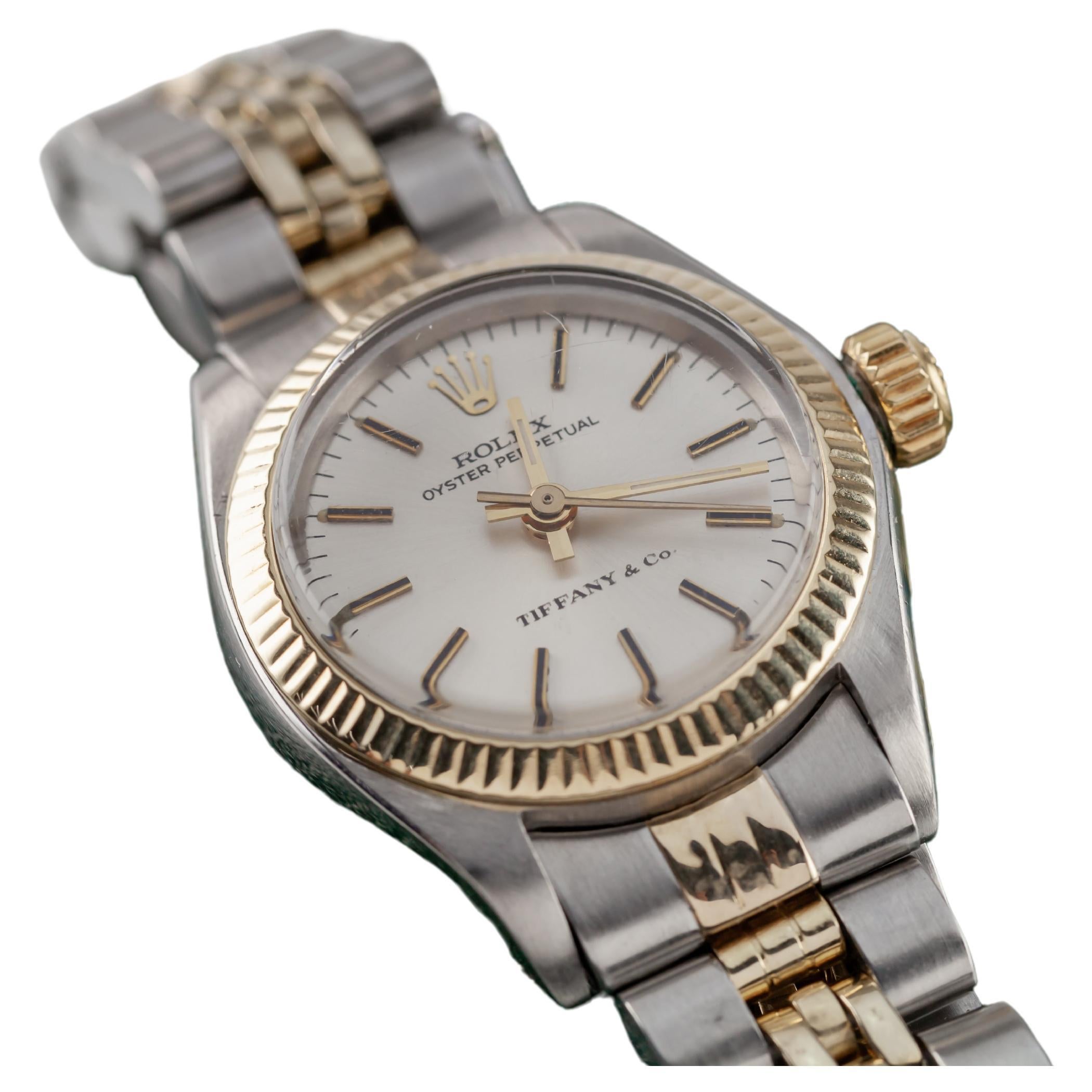 Rolex Two-Tone Stainless Steel and Gold Women's Datejust w/ Box 6917 Tiffany & Co.
Model: Datejust
Model #6719
Serial #3692XXX
Movement #2030
Movement Serial #949XX
Year: 1974

Stainless Steel Case w/ Fluted Gold Bezel
26 mm in Diameter
Lug-to-Lug