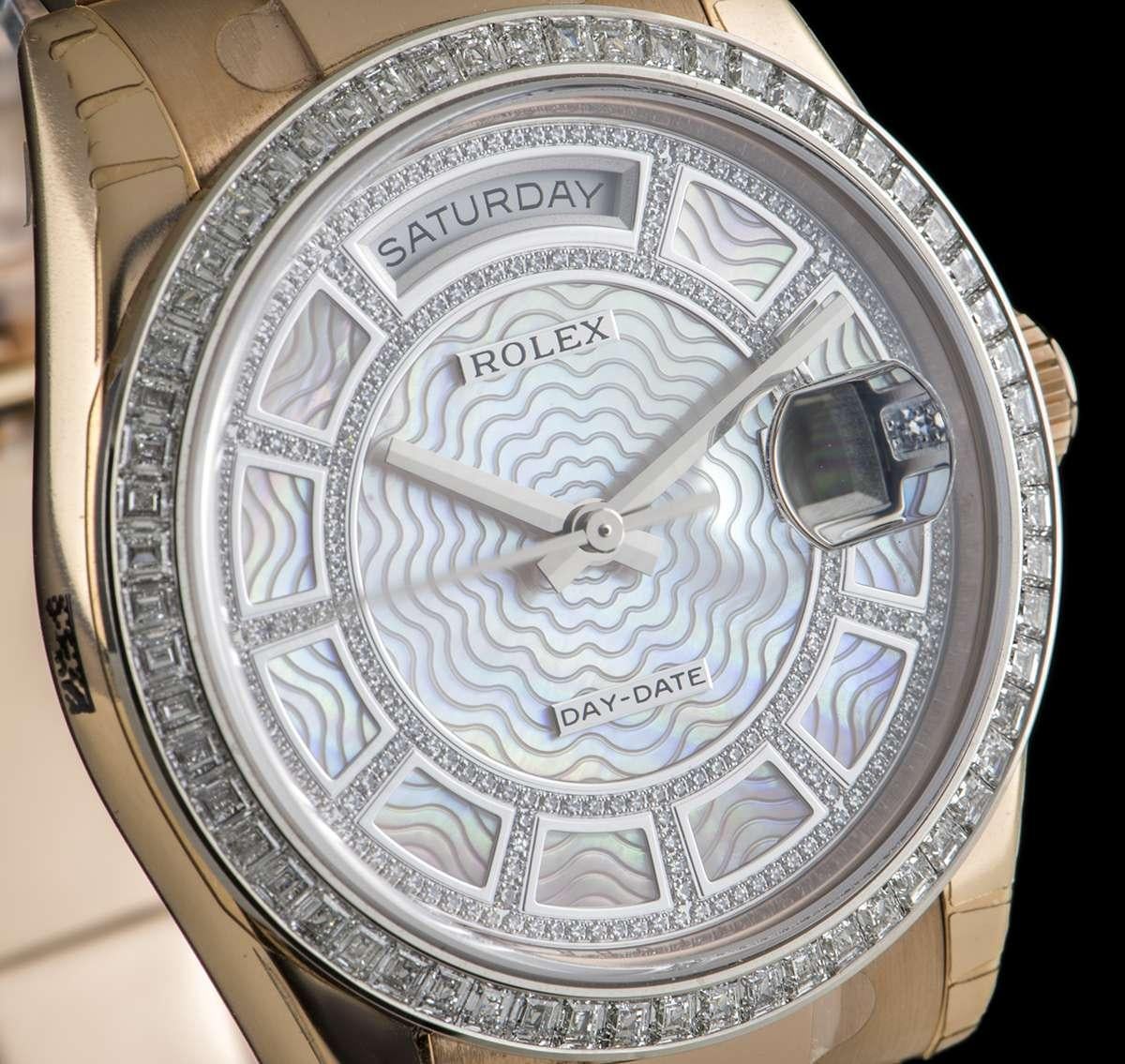 An Unworn 18k Rose Gold Day-Date Gents NOS 118395BR Wristwatch, pink mother of pearl carousel dial set with approximately 200 round brilliant cut diamonds, day at 12 0'clock, date at 3 0'clock, a fixed 18k white gold bezel set with approximately 60