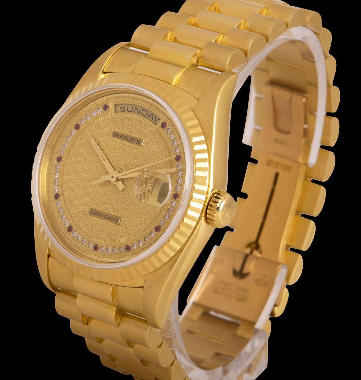 A 36 mm Very Rare 18k Yellow Gold Oyster Perpetual Day-Date Gents Wristwatch, decorated champagne dial set with a string of 40 applied round brilliant cut diamonds and 11 applied ruby hour markers, day at 12 0'clock, date at 3 0'clock, a fixed 18k