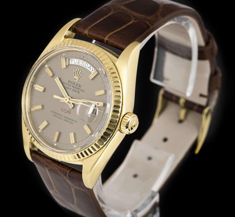 A Very Rare 36 mm 18k Yellow Gold Oyster Perpetual Day-Date Vintage Gents Wristwatch, grey dial with applied hour markers, day at 12 0'clock, date at 3 0'clock, Arabic inscription at 6 0'clock which translates to Qaboos, a fixed 18k yellow gold