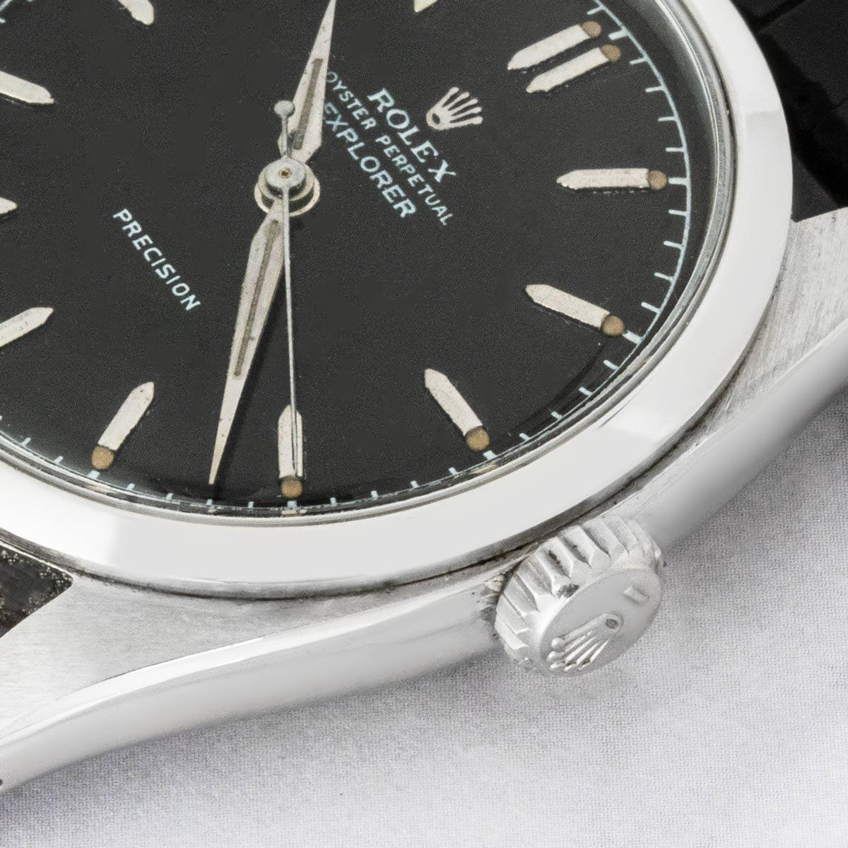 A vintage 36mm stainless steel Explorer Precision by Rolex. Features a black dial with applied hour markers, complemented by a smooth steel bezel. Fitted with plastic glass and a self-winding automatic movement. The piece is presented on a new