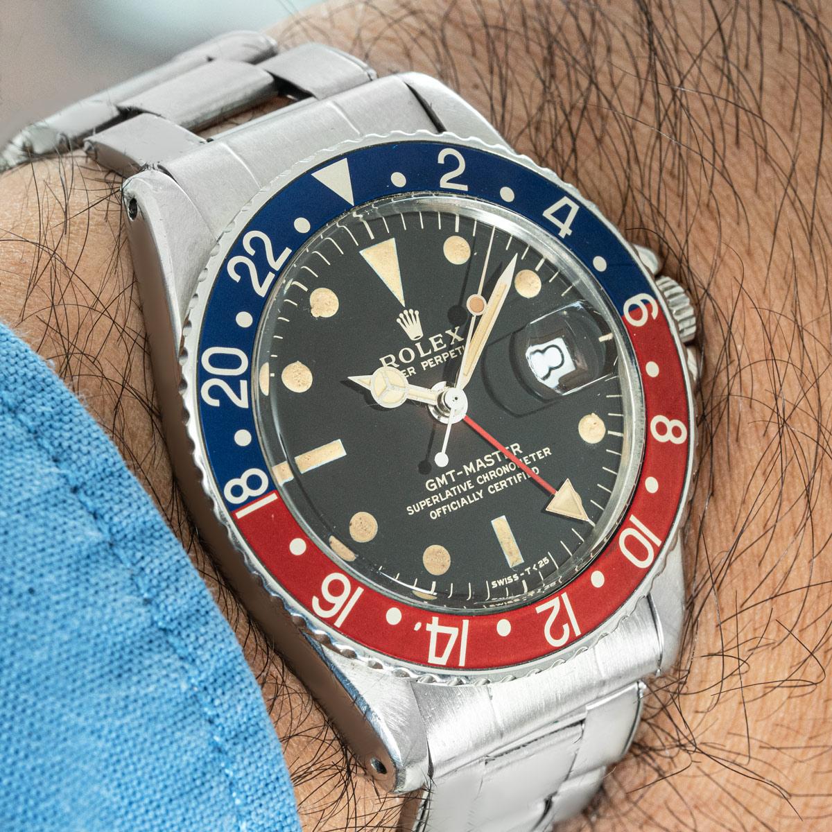 A vintage GMT-Master Pepsi in stainless steel by Rolex. Features a matte black gilt dial which over time has transformed into what is known as a Tropical dial. Complementing the case is a bi-directional rotatable bezel with the iconic blue and red