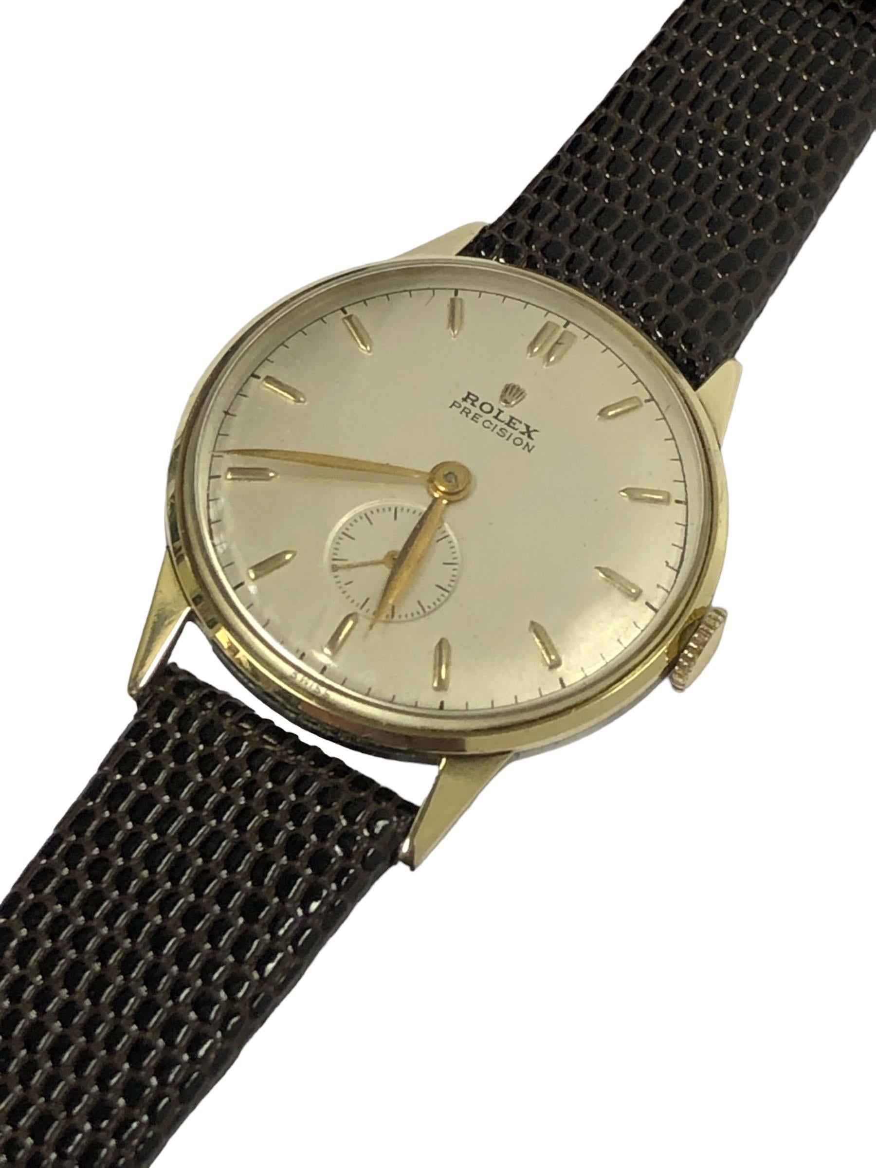 Circa 1952 Rolex Wrist Watch, 35 M.M 3 piece snap back case with Yellow Gold Bezel, Lug Tops and Crown. 17 Jewel Mechanical, Manual wind movement, older Quality Restored Silver Satin Dial with Raised Markers and a sub seconds Chapter, original