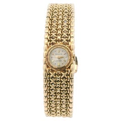 Rolex Montre vintage pour femmes en or jaune 18 carats avec lunette ciselée