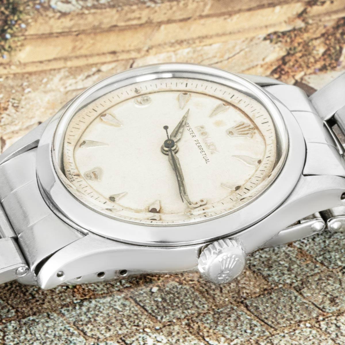 A rare vintage 34mm Oyster Perpetual in stainless steel by Rolex, known as the original Deepsea. Features a silver dial with Arabic numerals at 3, 6, and 9. The dial is encased by a smooth fixed bezel.

Fitted with plastic glass and a self-winding