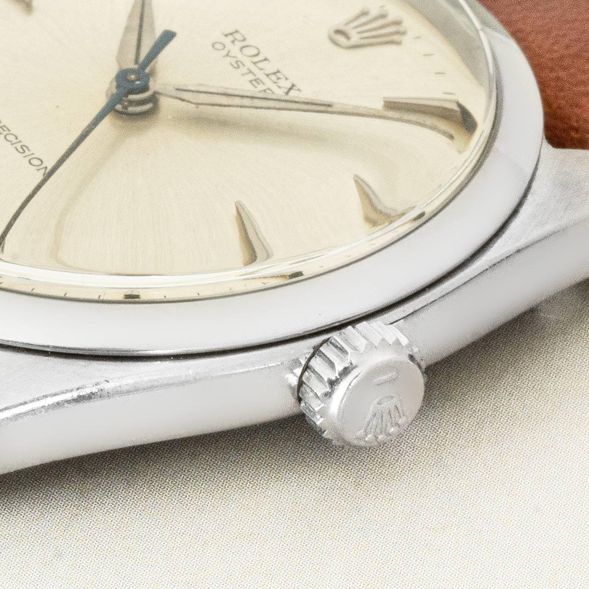 A 36mm vintage stainless steel Oyster Precision by Rolex. Features a silver dial, complemented by a smooth steel bezel. Fitted with plastic glass and a manual wind movement. The piece is presented on a new generic brown leather strap, equipped with