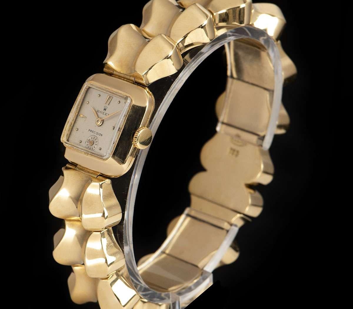 A Yellow Gold Precision Vintage Ladies Wristwatch, silver dial with applied hour markers, small seconds at 6 0'clock, a fixed yellow gold bezel, a yellow gold bracelet with a yellow gold jewellery style clasp, plastic glass, manual wind movement, in