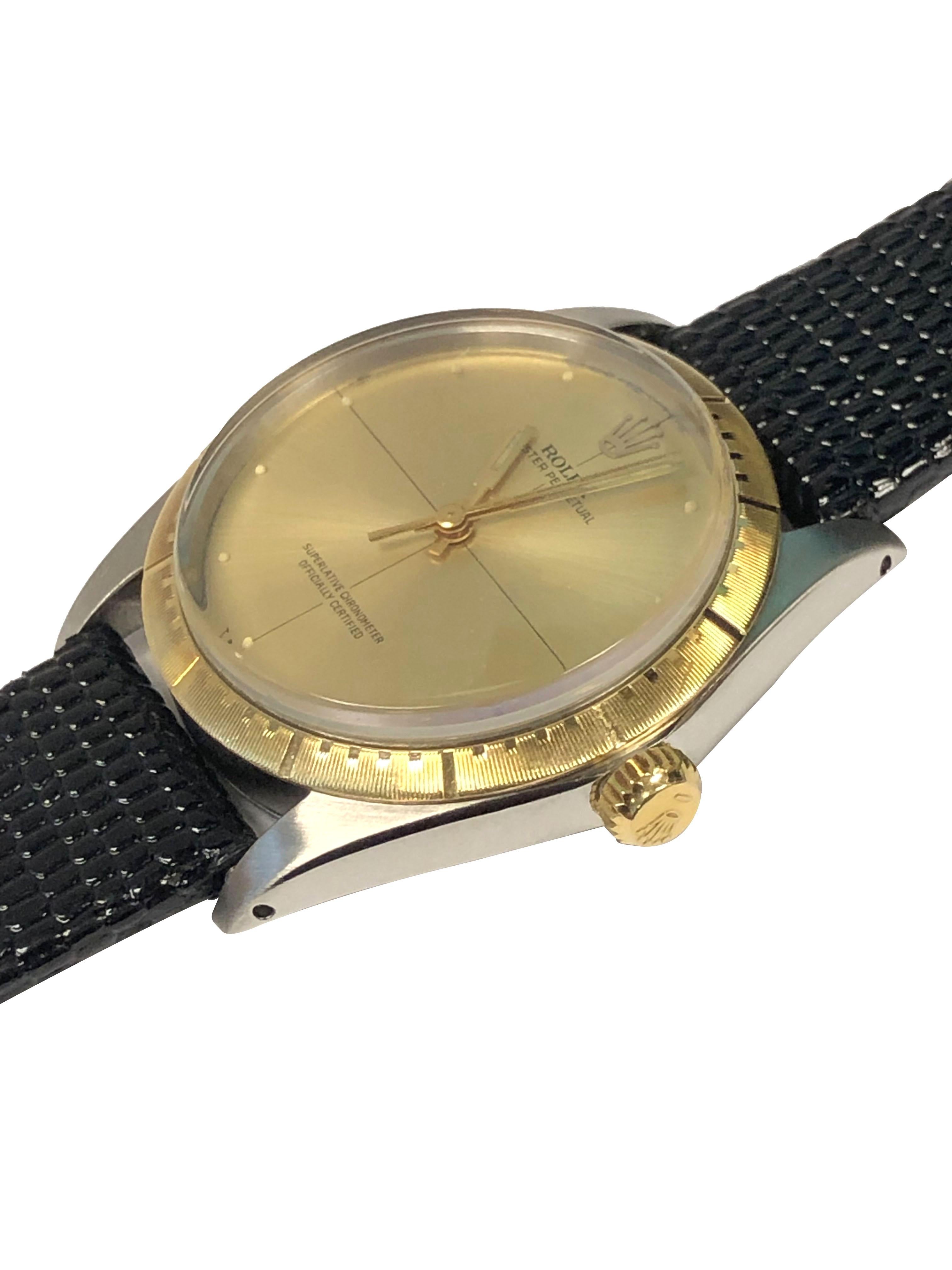 Circa 1967 Rolex Reference 1038 Wrist Watch, 35 M.M. 3 piece Stainless Steel case with 18k Zephyr Bezel and Gold crown. Caliber 1570 Automatic, Self winding movement, Original and Mint condition Gold Satin dial with applied Dot markers, Gilt hands