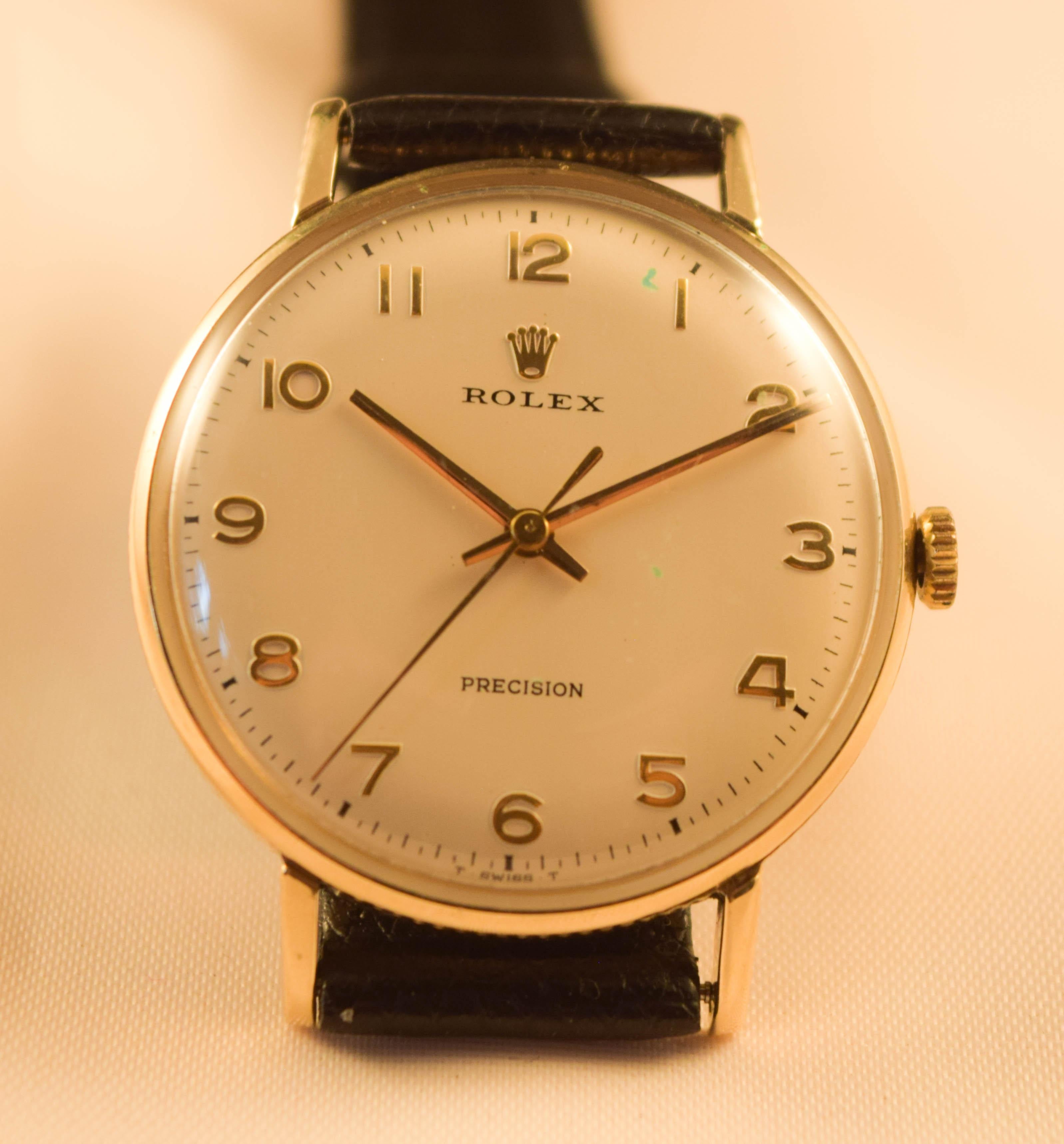 This is a very rare Coin edged Rolex watch
Dial is signed Rrolex Precision
Raised gold Rolex Crown
Raised Gold numbers
Gold Hands
Movement is signed Montres Rolex Geneva Suisse
Solid 9 K gold case Stamped hall marks
0.375
There is  a very small dent