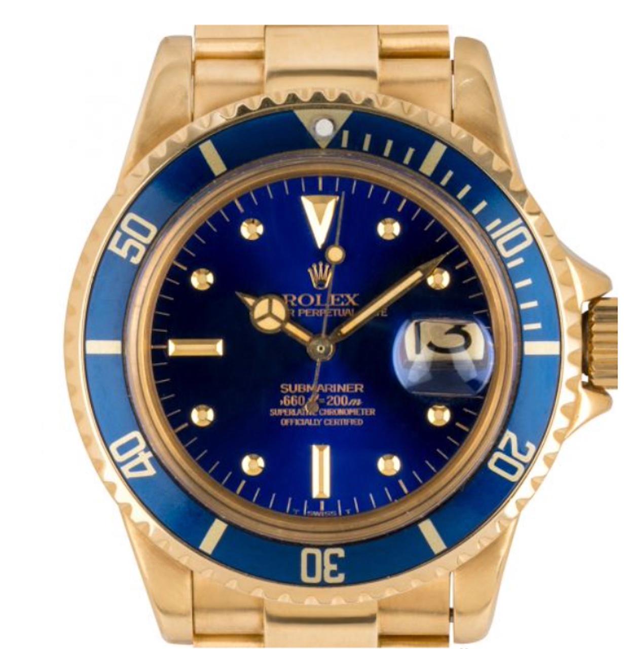 A vintage yellow gold Submariner Date. Featuring a rare distinctive blue dial coined the nipple dial, due to the protruding hour markers made of precious metals in this case yellow gold. For example, the round applied hour markers are filled with