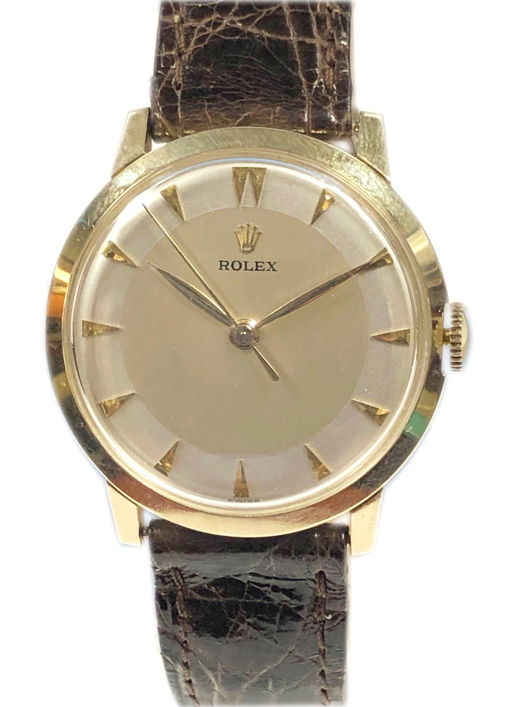 Circa 1960s Rolex Wrist Watch, 33 M.M. 14K 2 piece case, 9 M.M. thick, 17 Jewel Mechanical, Manual wind Nickle lever movement, 2 tone Silver Satin Pie pan dial with raised Gold markers and a sweep seconds hand. New deBeer Brown Crocodile  strap with