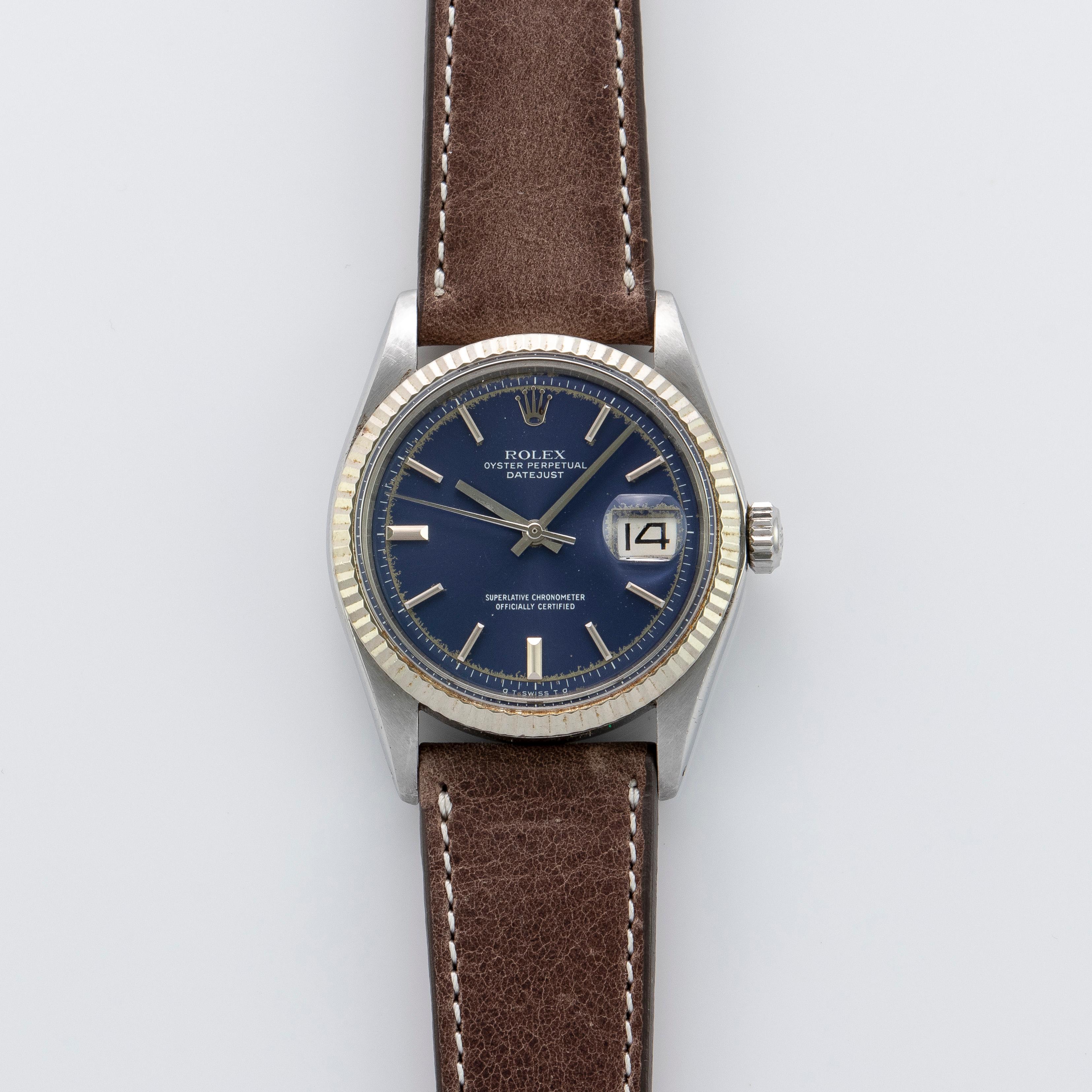 Rolex Stainless Steel and White Gold Oyster Perpetual Datejust Watch
Factory Blue Sigma Dial with Silver Applied Markers
Dial Shows Some Aging and Color Loss Around Edges
White Gold Gold Fluted Bezel
Stainless Steel Case
36mm in size 
Features Rolex