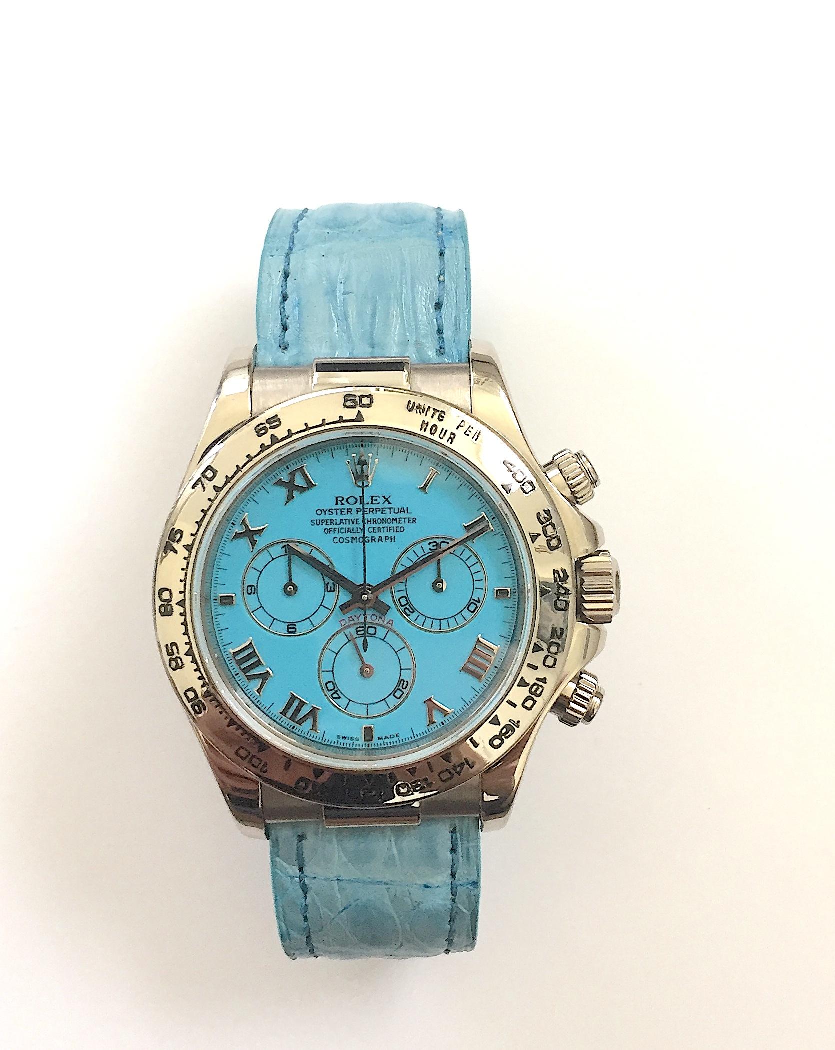 Rolex 18K White Gold Oyster Perpetual Cosmograph Daytona Wristwatch
Rare Factory Blue Turquoise Dial with Three Sub-Dials
18K White Gold Bezel Which Shows Wear and Some Use
40mm in size 
Rolex Calibre 4130 Automatic Chronograph Movement
Sapphire