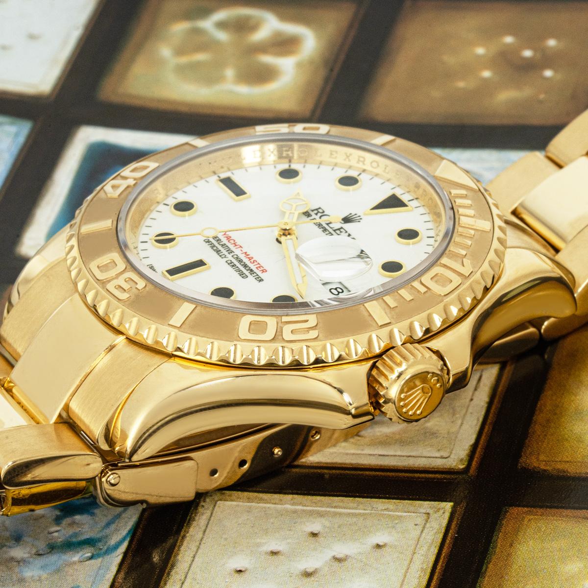 A 40mm Yacht-Master in yellow gold by Rolex. Featuring a white dial with applied hour markers, date aperture at 3 o'clock, and a bi-directional rotating bezel in yellow gold.

The watch is fitted with a sapphire glass, self-winding automatic