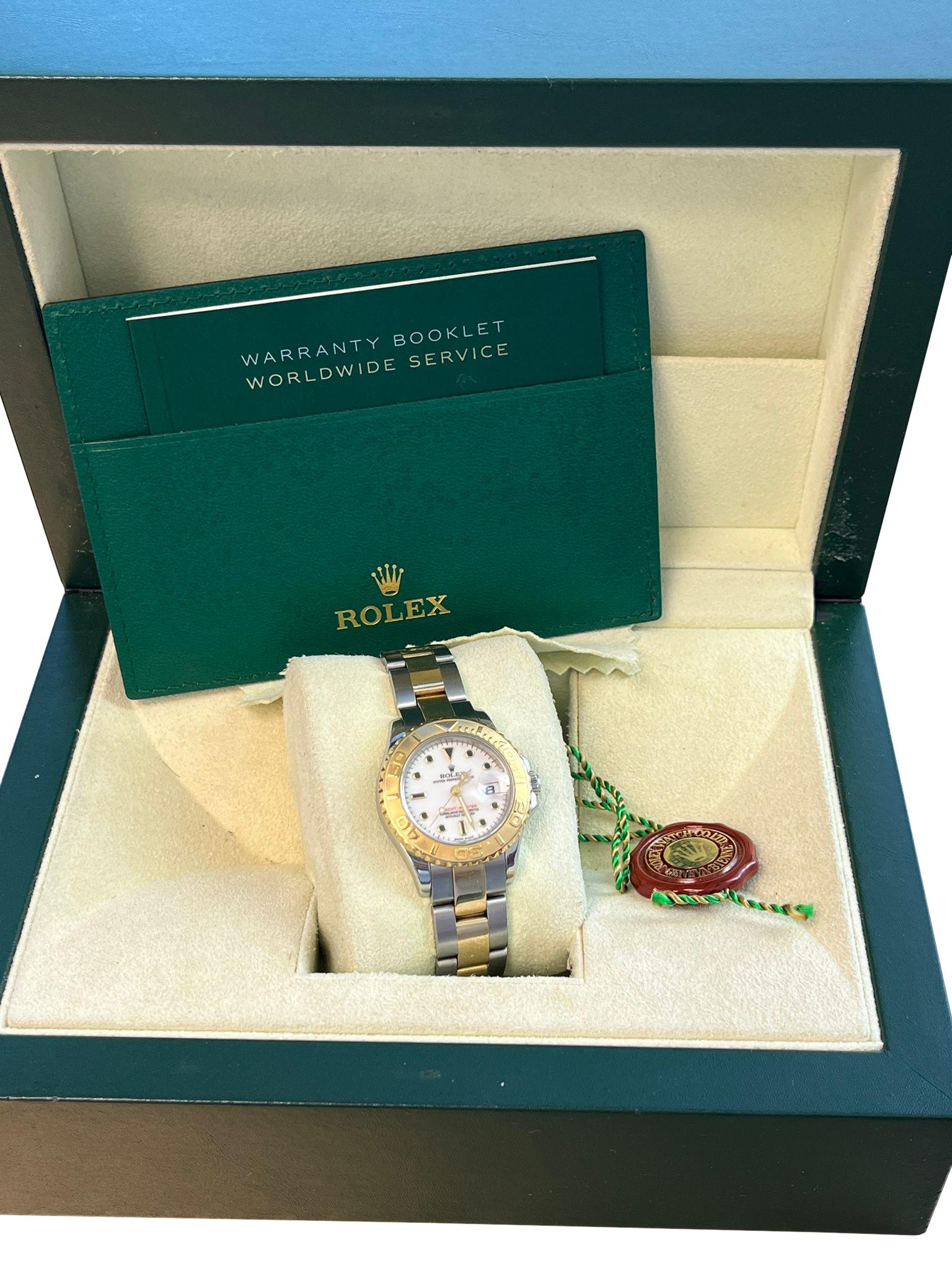 This stunning Rolex Yacht-Master 29 169623 watch is crafted from a combination of stainless steel and 18k yellow gold. The 29mm case houses a white dial with dot and index hour markers and a date window at 3 o'clock. The two-tone oyster bracelet is