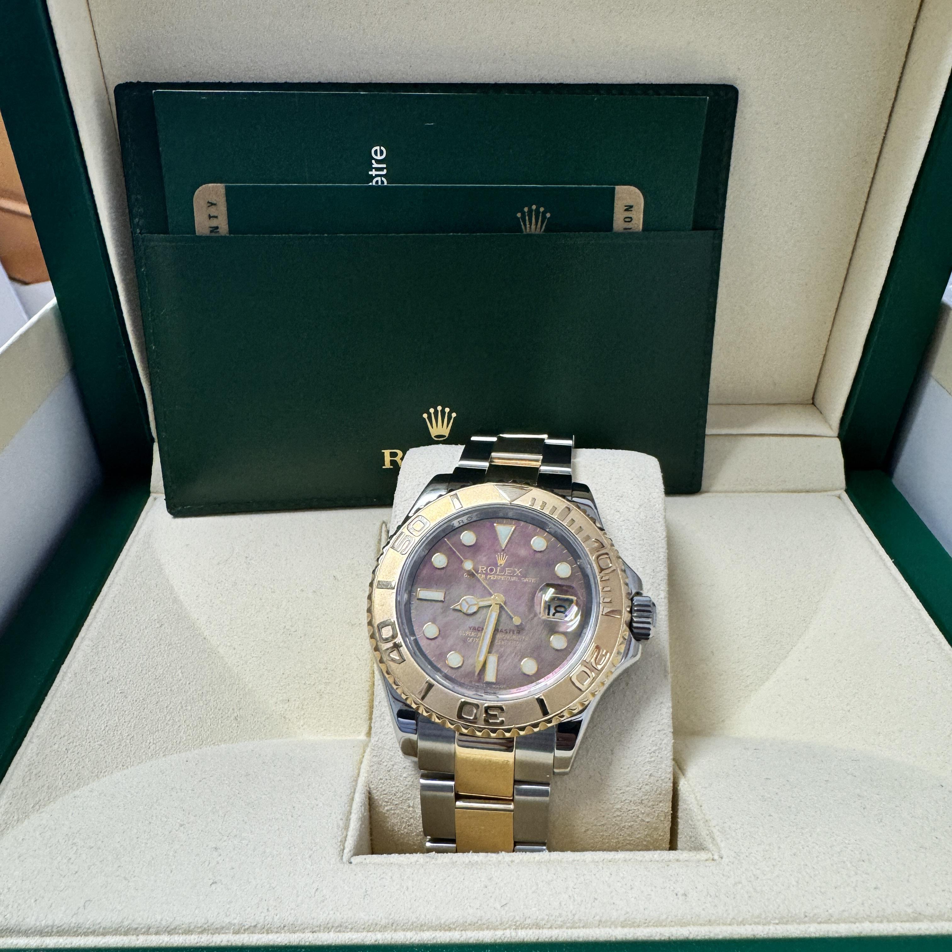Rolex Yacht-Master 40mm Ref. 16623, featuring a 100% original and rare black mother-of-pearl dial, two-tone stainless steel and 18K yellow gold case, and a luxurious Oyster bracelet.

All parts original Rolex. Complete with the original box and