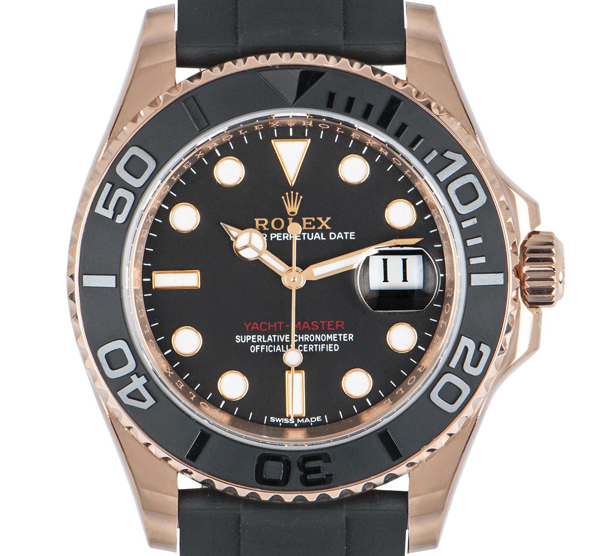 A mens 40mm Yacht-Master in rose gold by Rolex. Featuring an intense black dial with the date and a matt black ceramic bidirectional rotatable bezel with raised 60-minute numerals and graduations.

The black Oysterflex bracelet comes with a folding