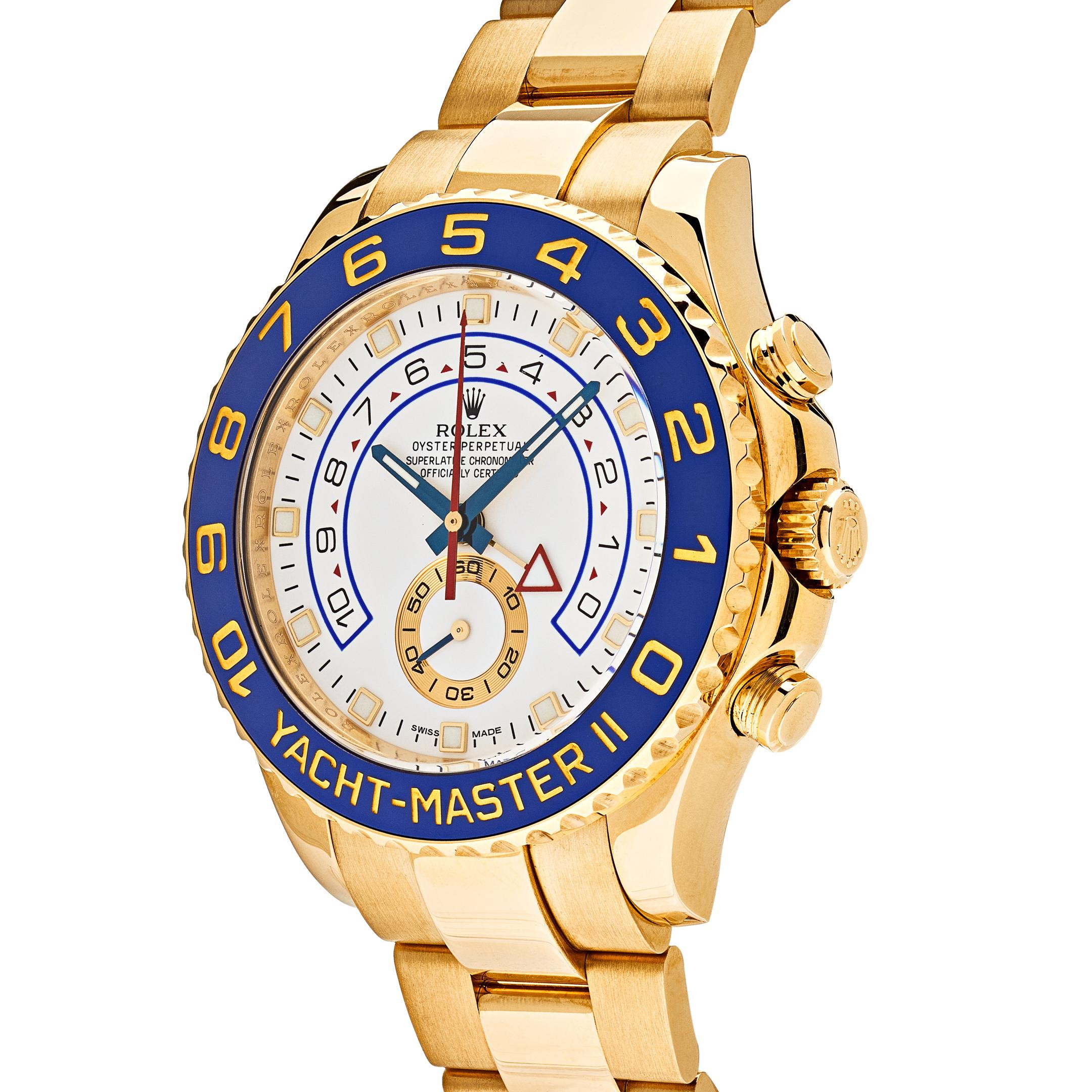 This Rolex Yacht-Master II is designed in a 44mm 18K yellow gold case. It features a white dial with gold illuminating hands and index hour markers. The bracelet is crafted in 18K yellow gold with a fold-over clasp with safety.
 
*This watch has