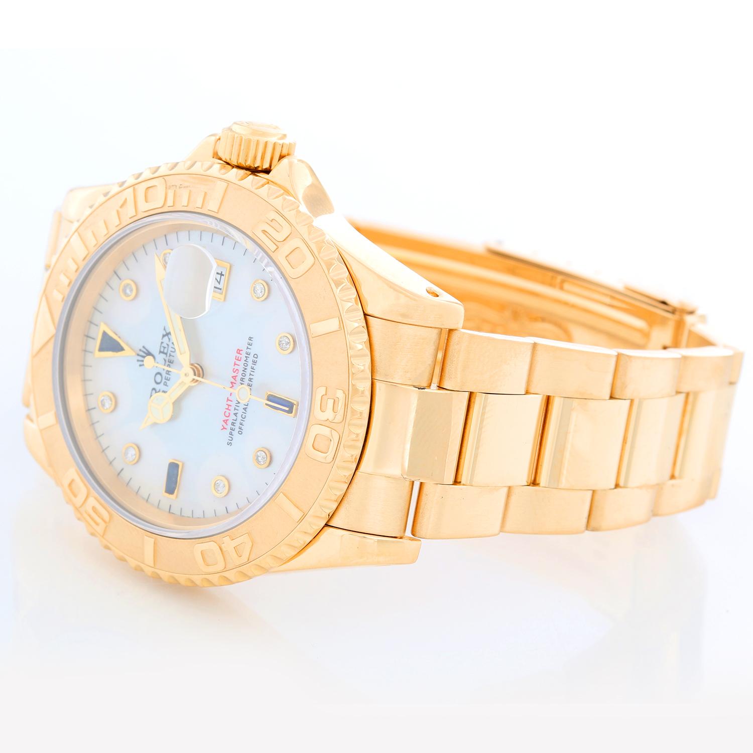 Rolex Yacht-Master Men's 18k Yellow Gold Watch Mother of Pearl 16628 - Automatic winding, 31 jewels, Quickset, sapphire crystal. 18k yellow gold case and bezel  (40mm diameter). Mother of Pearl with diamond and sapphire hour markers. 18k yellow gold