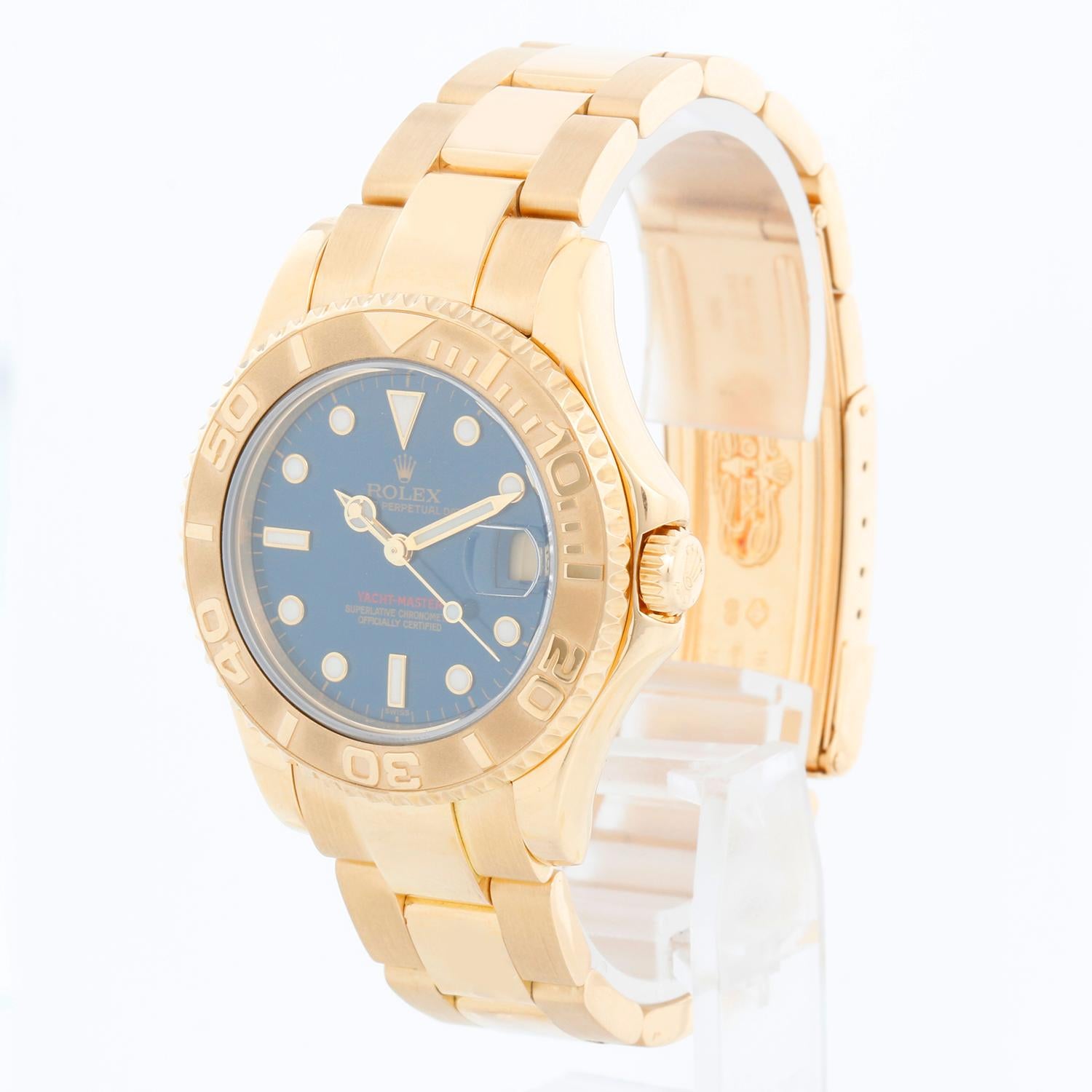 Rolex Yacht-Master Midsize Men's/Ladies 18k Gold Watch 68628 - Automatic winding, 29 jewels, sapphire crystal. 18k yellow gold case with rotating bezel (35mm diameter). Blue  dial with black hour markers. 18k yellow gold Oyster bracelet with