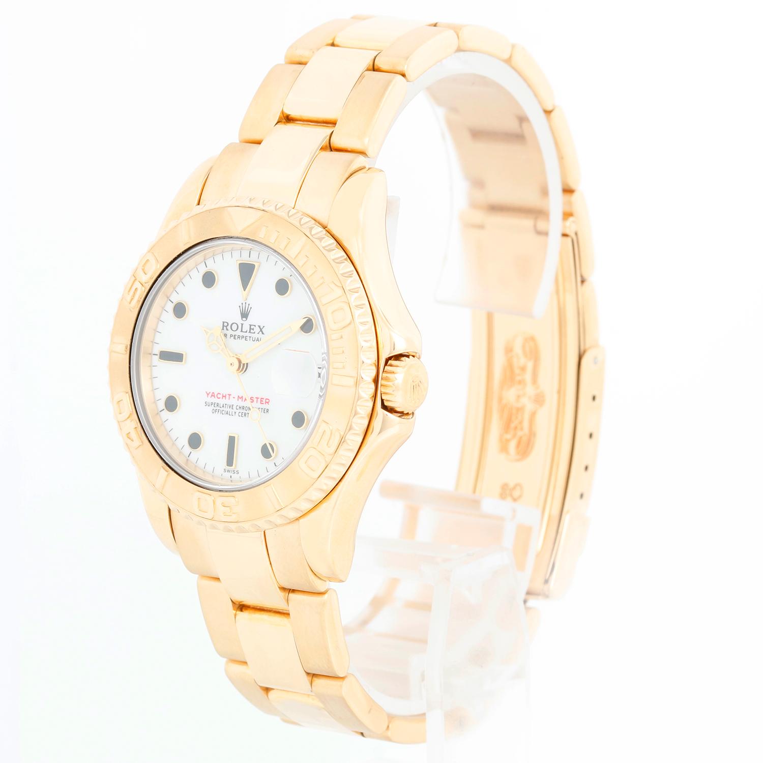 Rolex Yacht-Master Midsize Men's/Ladies 18k Gold Watch 68628 - Automatic winding, 29 jewels, sapphire crystal. 18k yellow gold case with rotating bezel (35mm diameter). White dial with black markers. 18k yellow gold Oyster bracelet with flip-lock