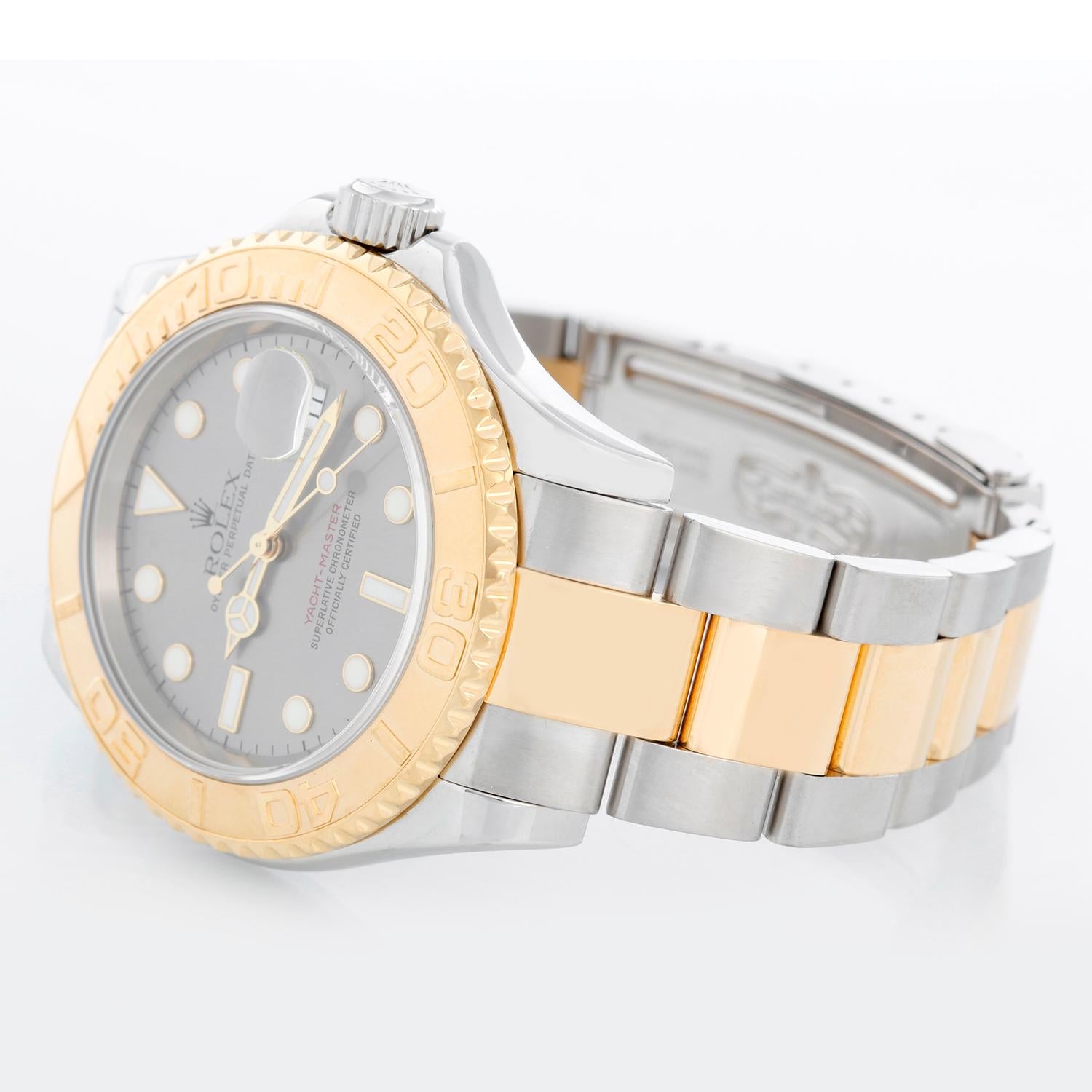 Rolex Yacht-Master Steel & Gold Men's 2-Tone Watch 16623 - Automatic winding, 31 jewels, Quickset, sapphire crystal. Stainless steel case with 18k yellow gold bezel  (40mm diameter).  Slate gray steel dial with luminous style hour markers; date at 3